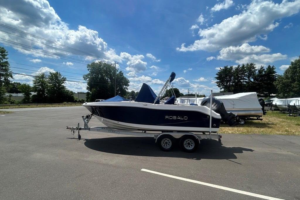2017 Robalo R200ES boat on trailer under a clear blue sky.