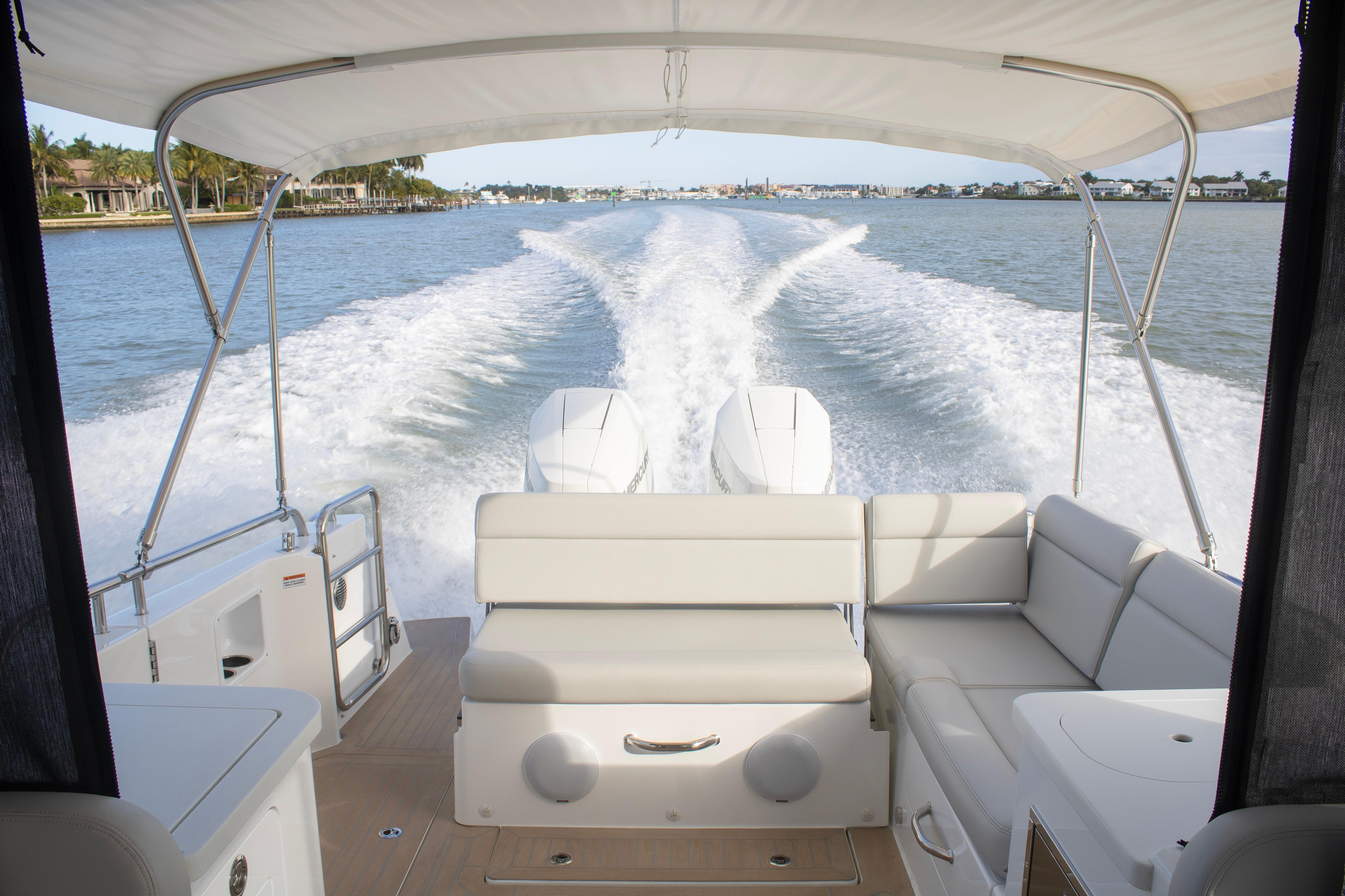 2025 MJM 38 X boat cruising on water, view from rear seating area.