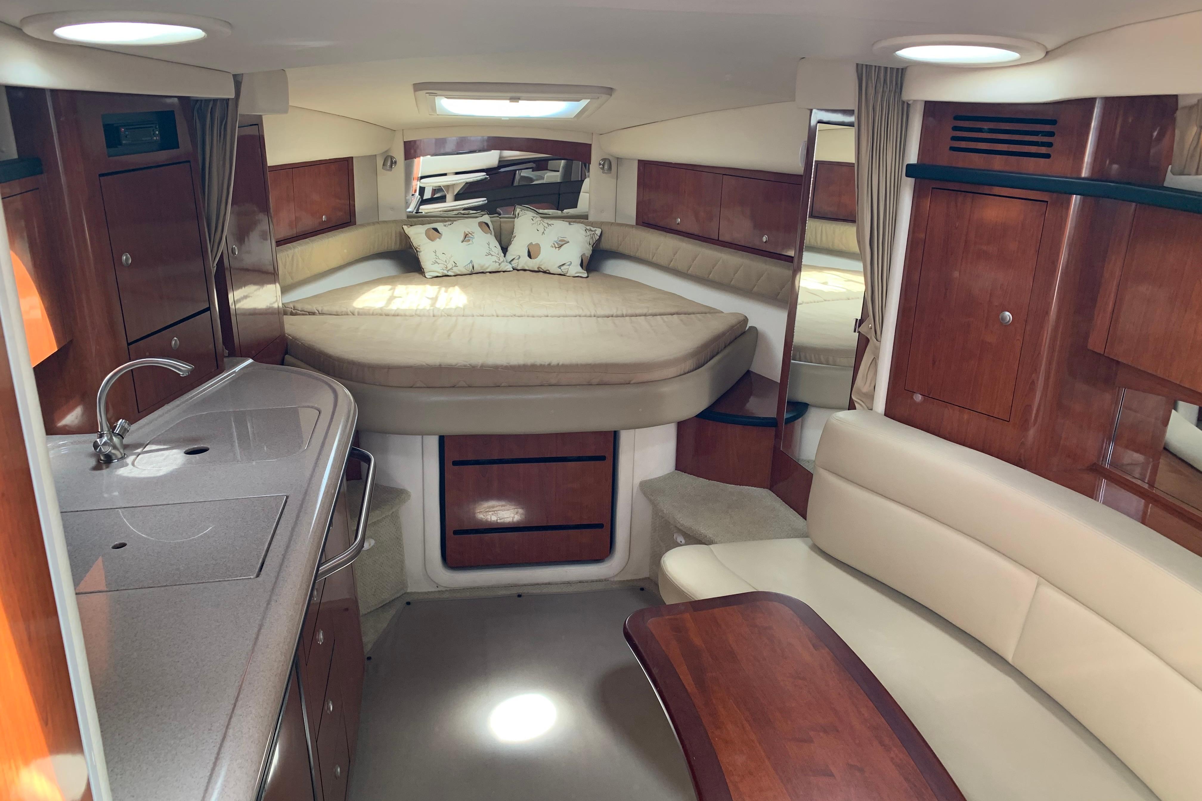 Interior of 2007 Sea Ray 340 Sundancer yacht with cozy cabin and kitchenette.