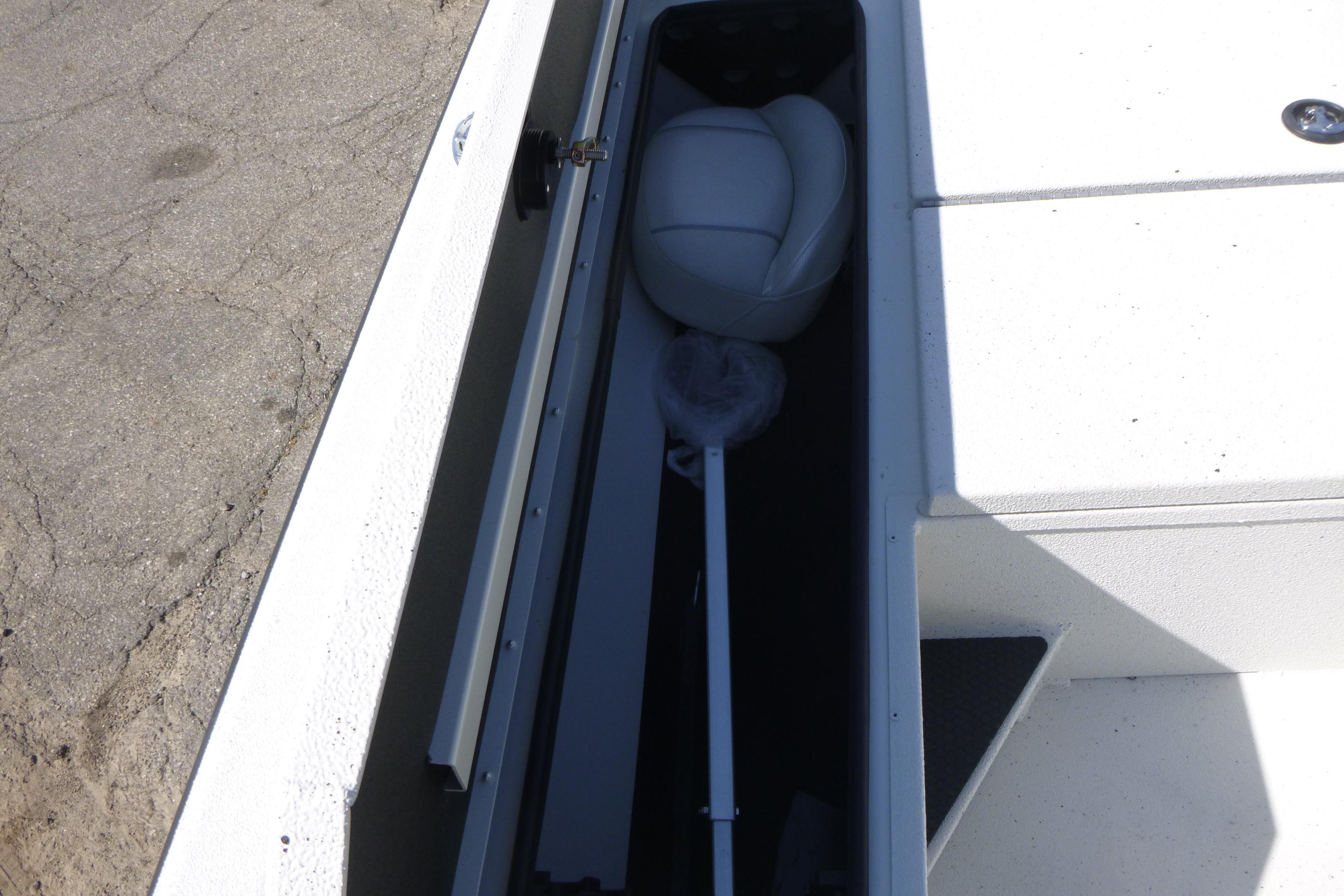 2025 Ranger RB210 boat storage compartment with seat and equipment.