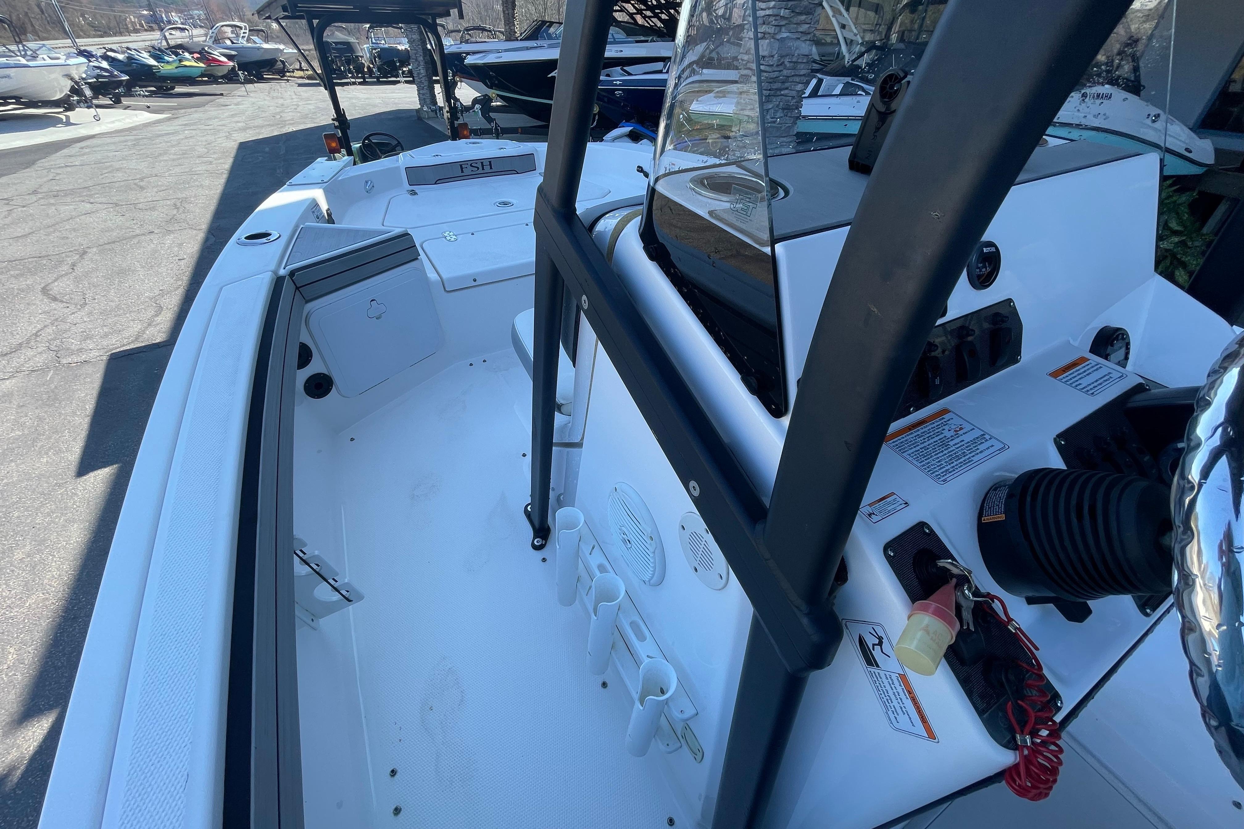 2021 Yamaha Boats 195 FSH Sport interior, showcasing helm and seating area.