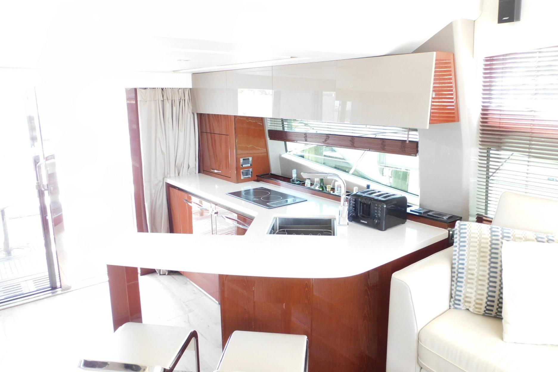 Luxurious interior of 2019 Sea Ray L550 yacht featuring modern kitchen design.