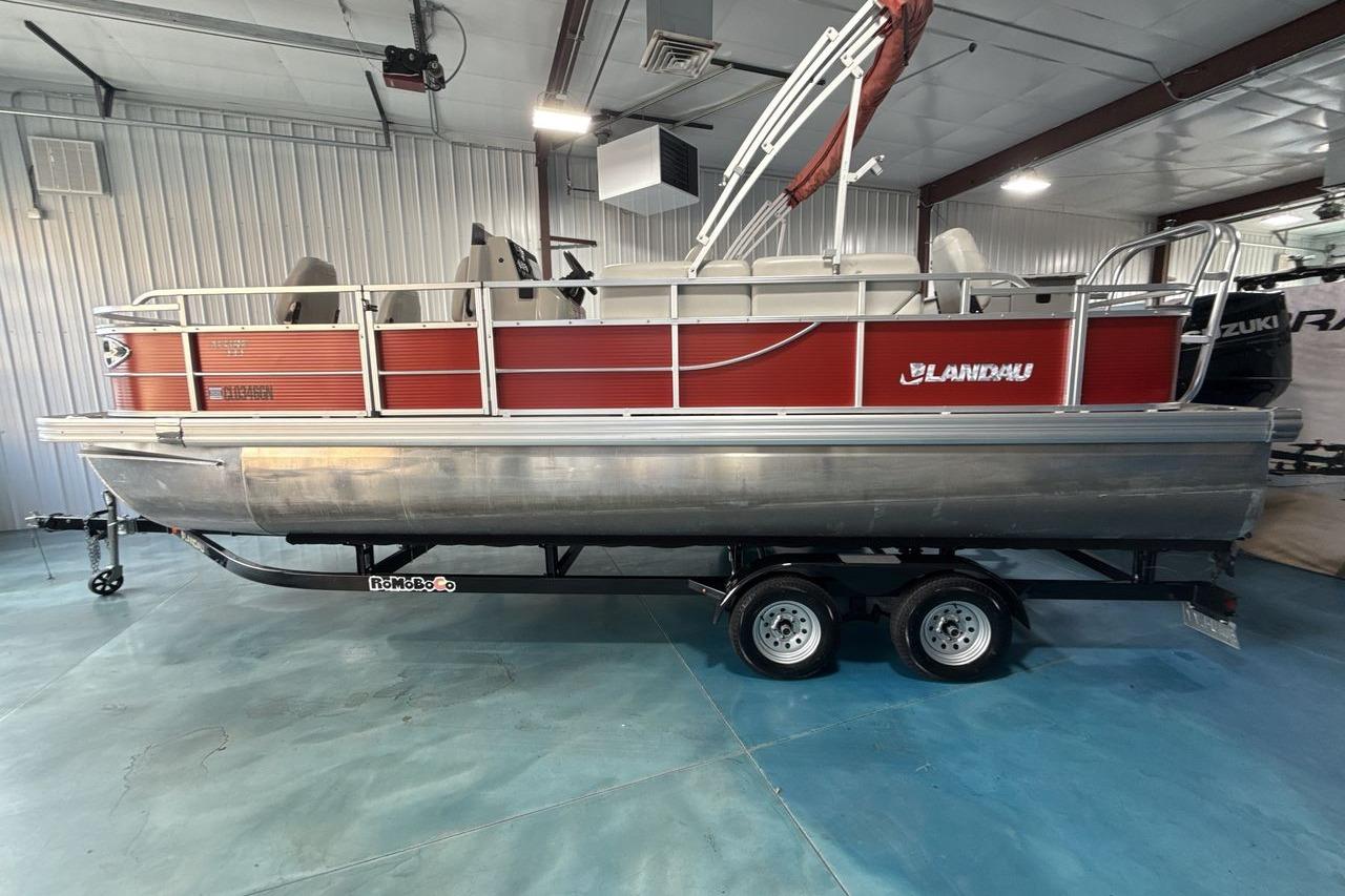 2022 Landau ALURE 232 pontoon boat on trailer in indoor showroom.