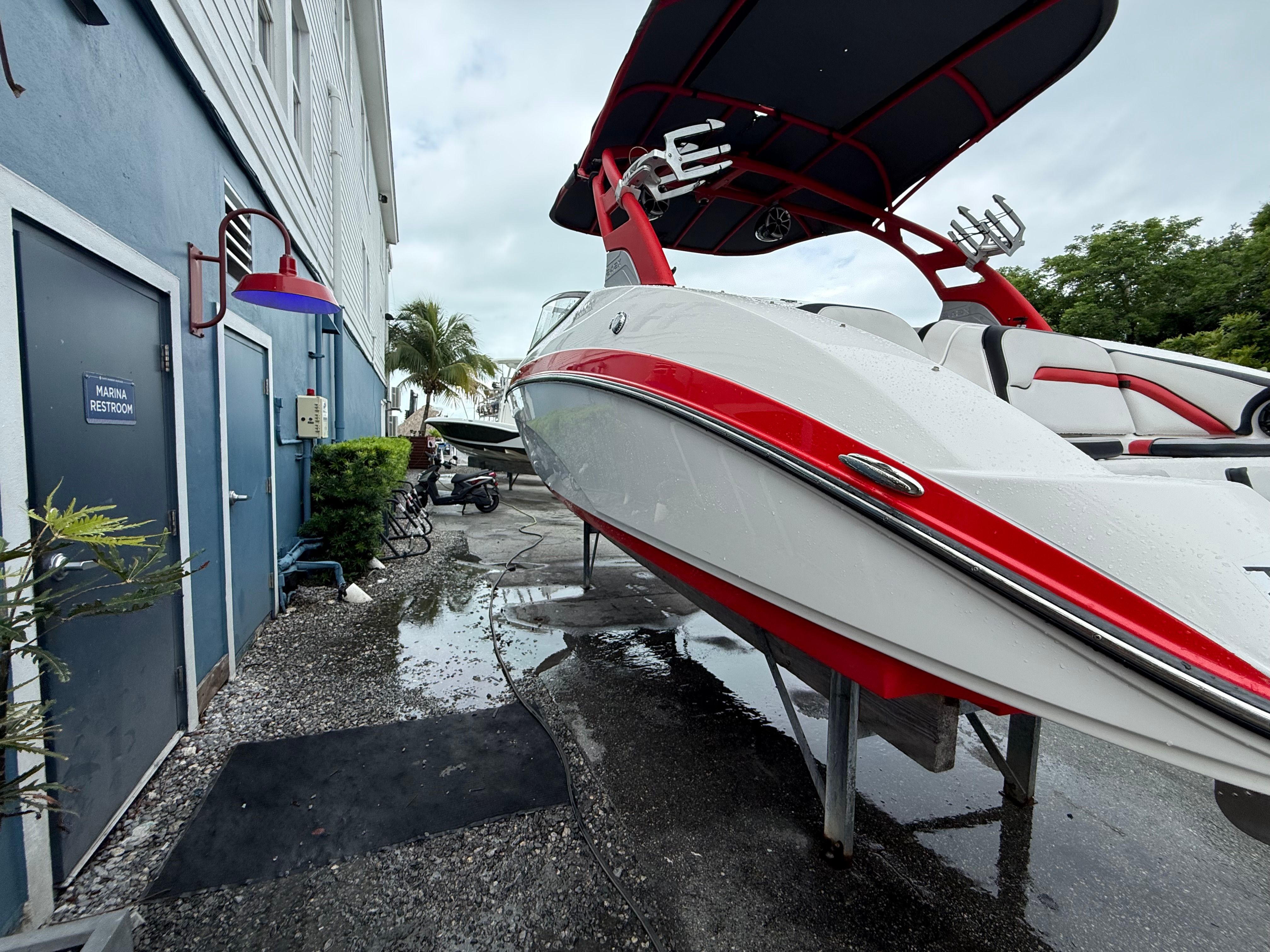 2020 Yamaha AR242X boat beside a blue building.