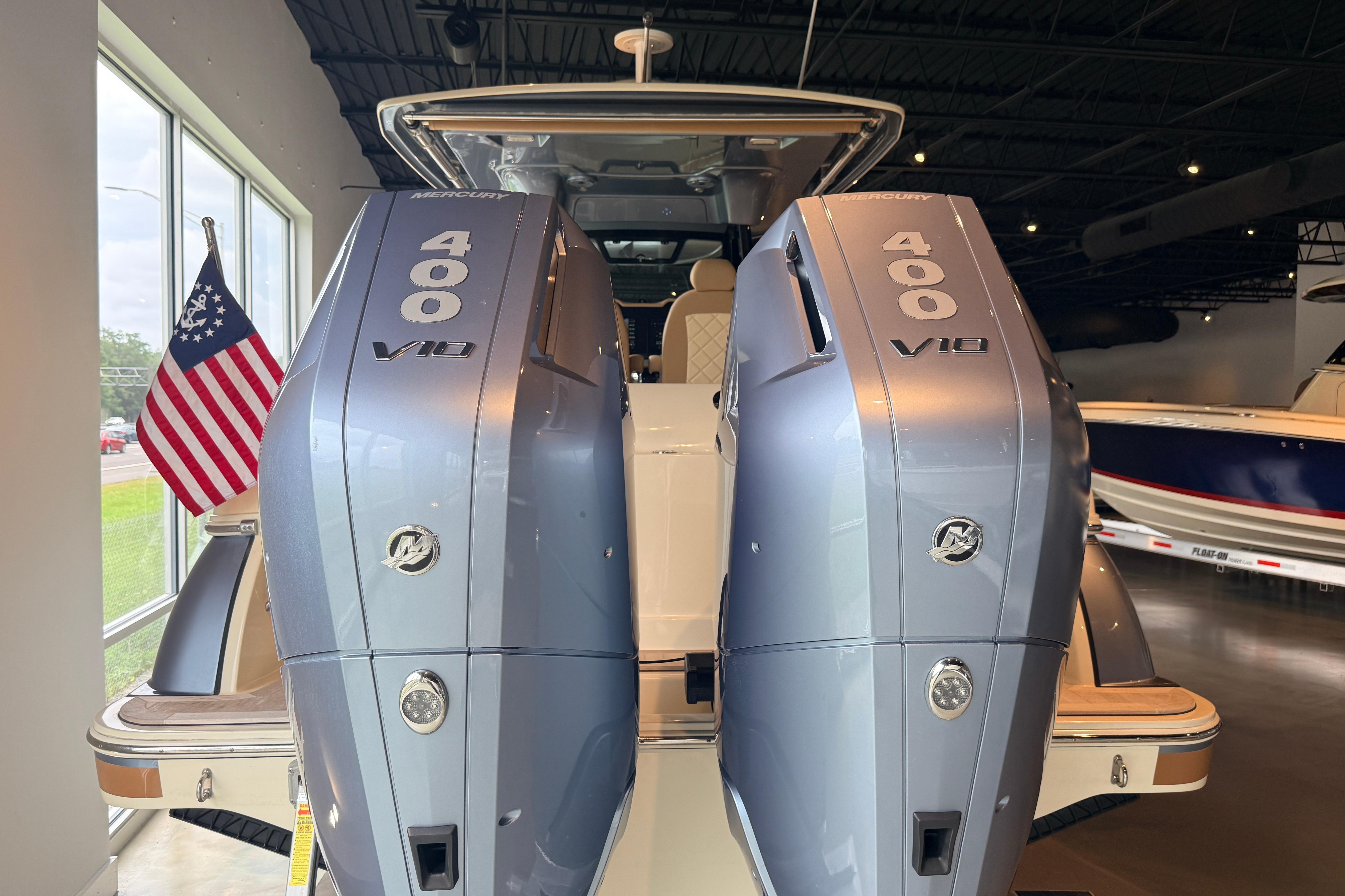 2024 Chris-Craft Catalina 30 with dual Mercury 400 V10 engines, displayed indoors.