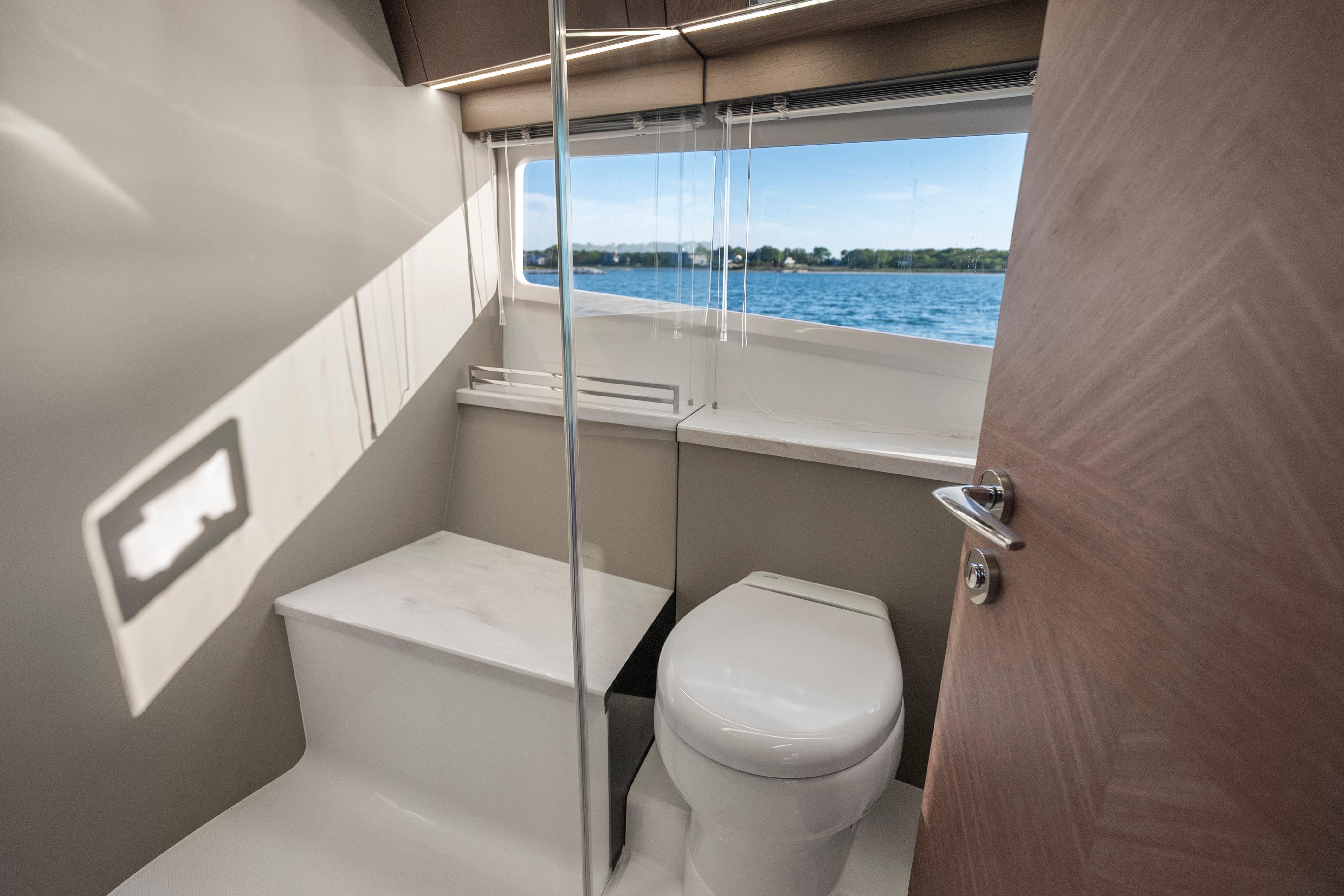 Modern bathroom interior on 2023 Galeon 400 Fly yacht with scenic window view.
