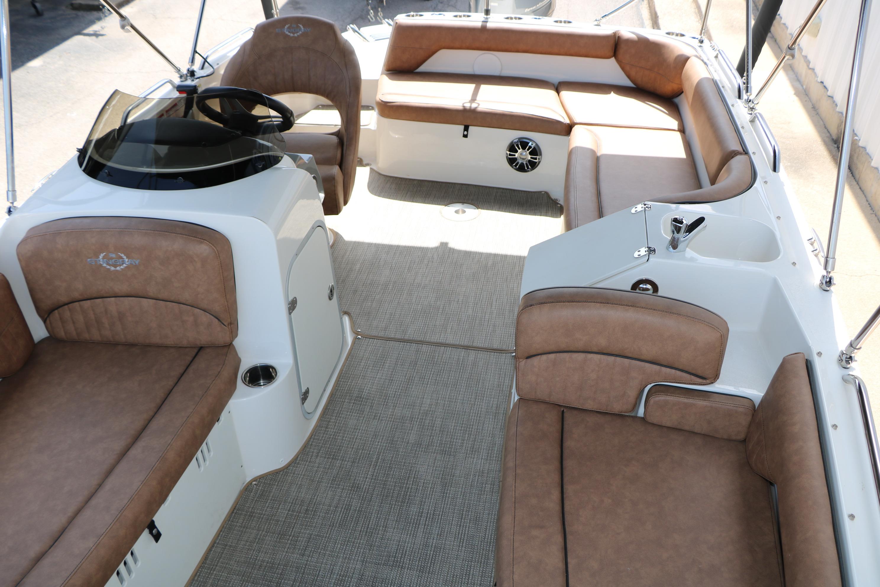 2022 Stingray 192 SC boat interior with tan seating and modern helm design.