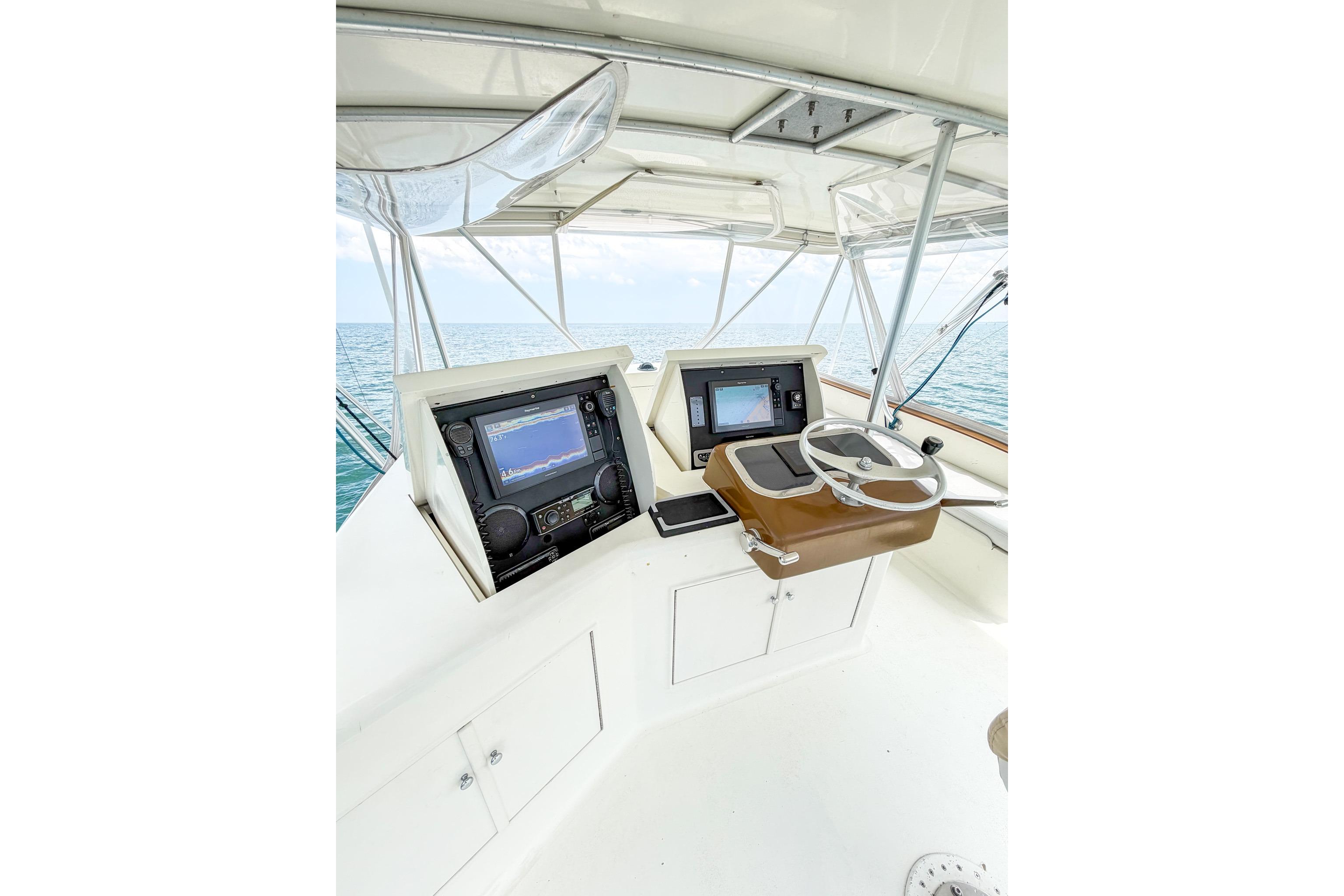 Helm of 1998 Blackwell Custom Carolina Sportfish with navigation equipment, overlooking the ocean.