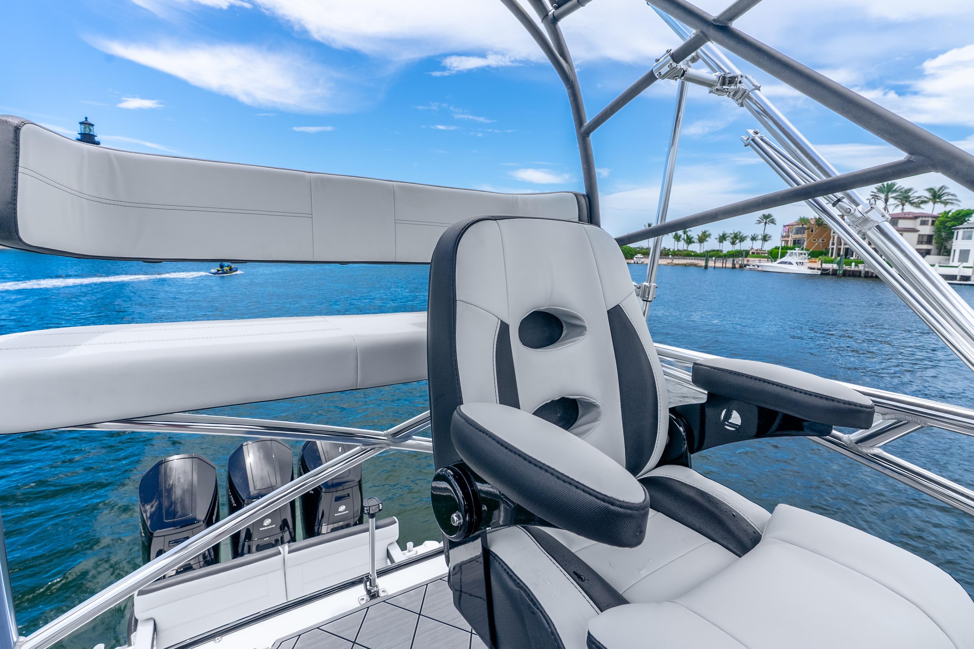 2024 Nor-Tech 452 Super Fish boat interior with luxurious seating and scenic waterfront view.