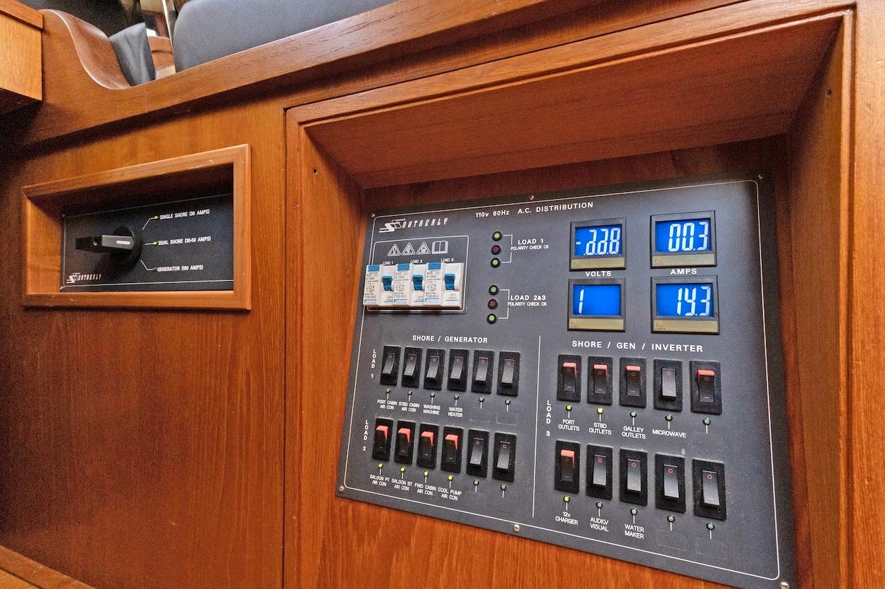 Electrical control panel on a 2011 Southerly 57 RS yacht, featuring voltage and amperage displays.