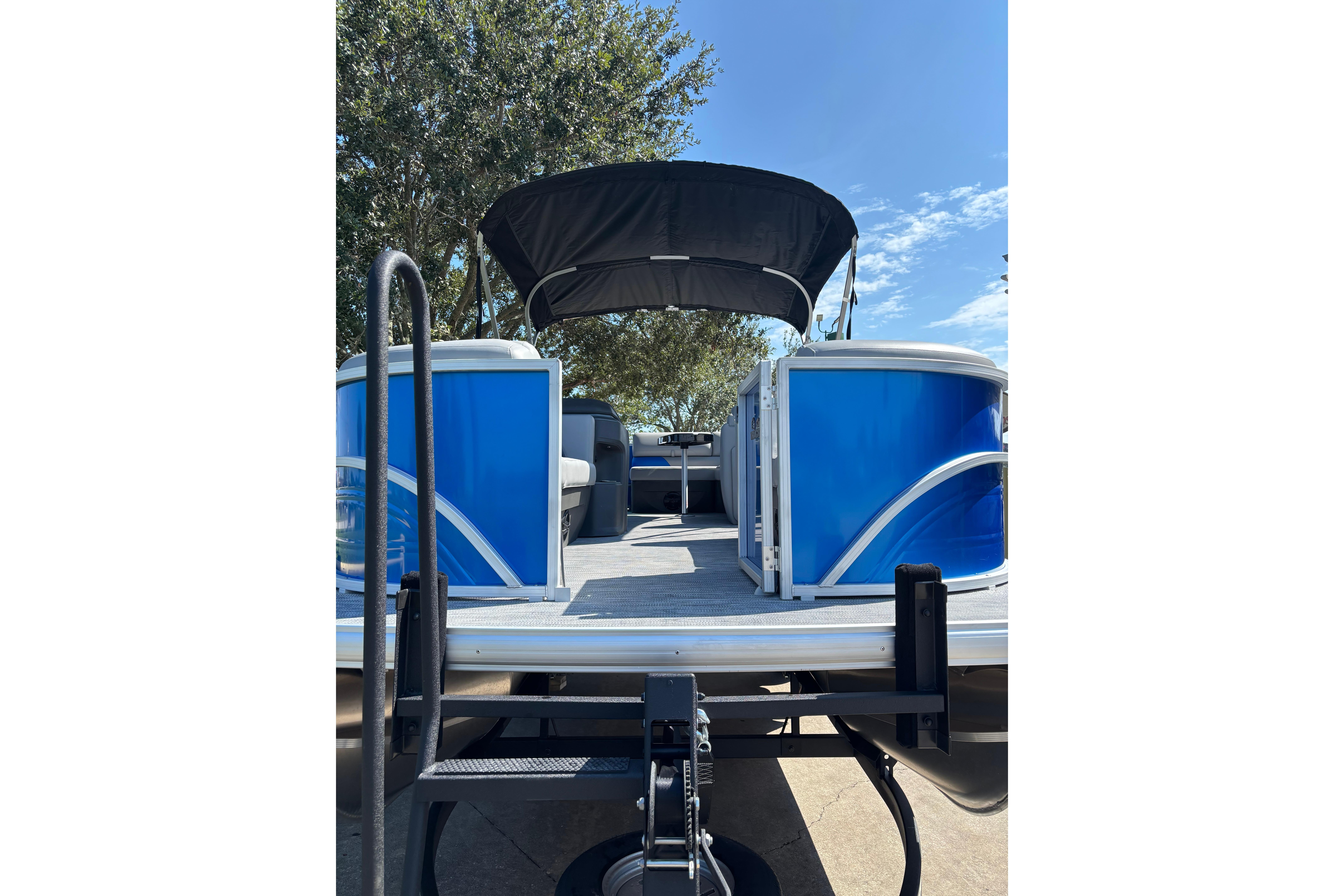 2026 Sun Tracker Party Barge 20 DLX pontoon boat with blue exterior and canopy.