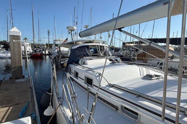Sailboat docked in marina, Reliance 44 model, 2011, with clear blue sky.