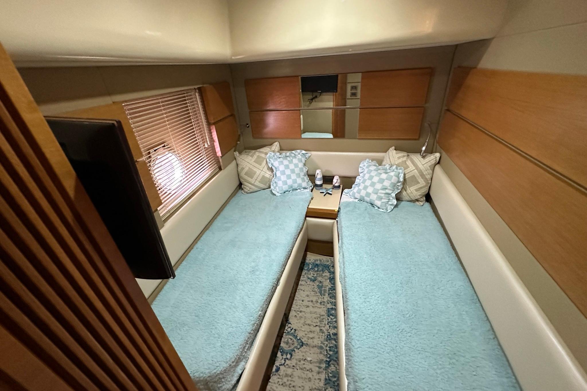 Luxurious 2013 Azimut Fly 53 yacht cabin with twin beds and elegant decor.