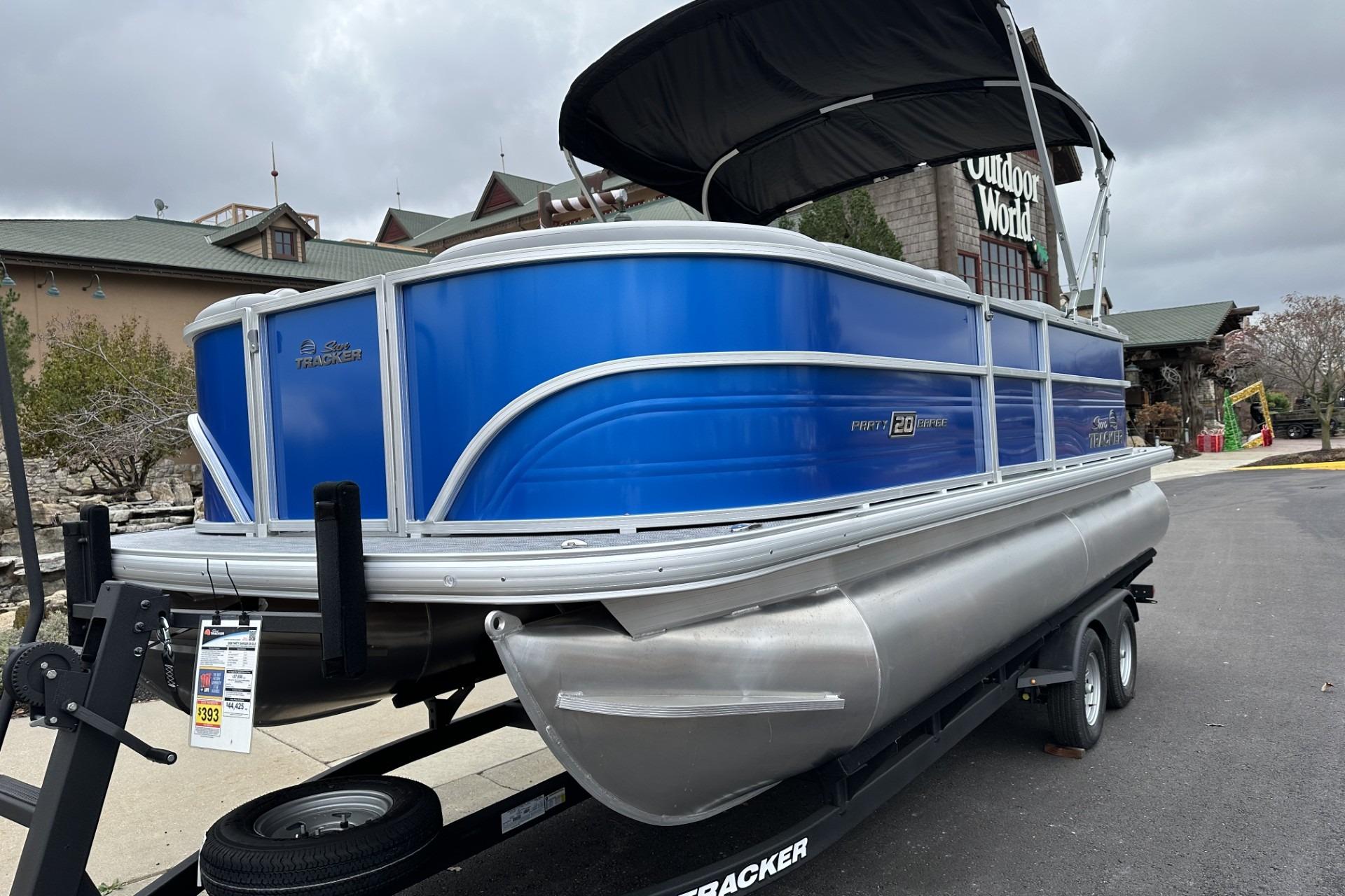 2026 Sun Tracker Party Barge 20 DLX pontoon boat on trailer, outdoor setting.