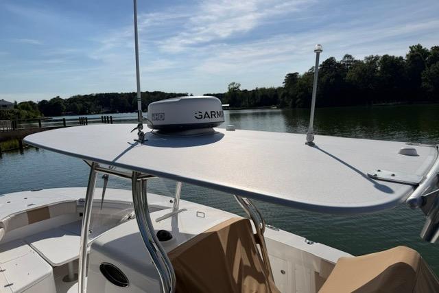 2014 Southport 29 FE boat with radar, docked on a serene lake.