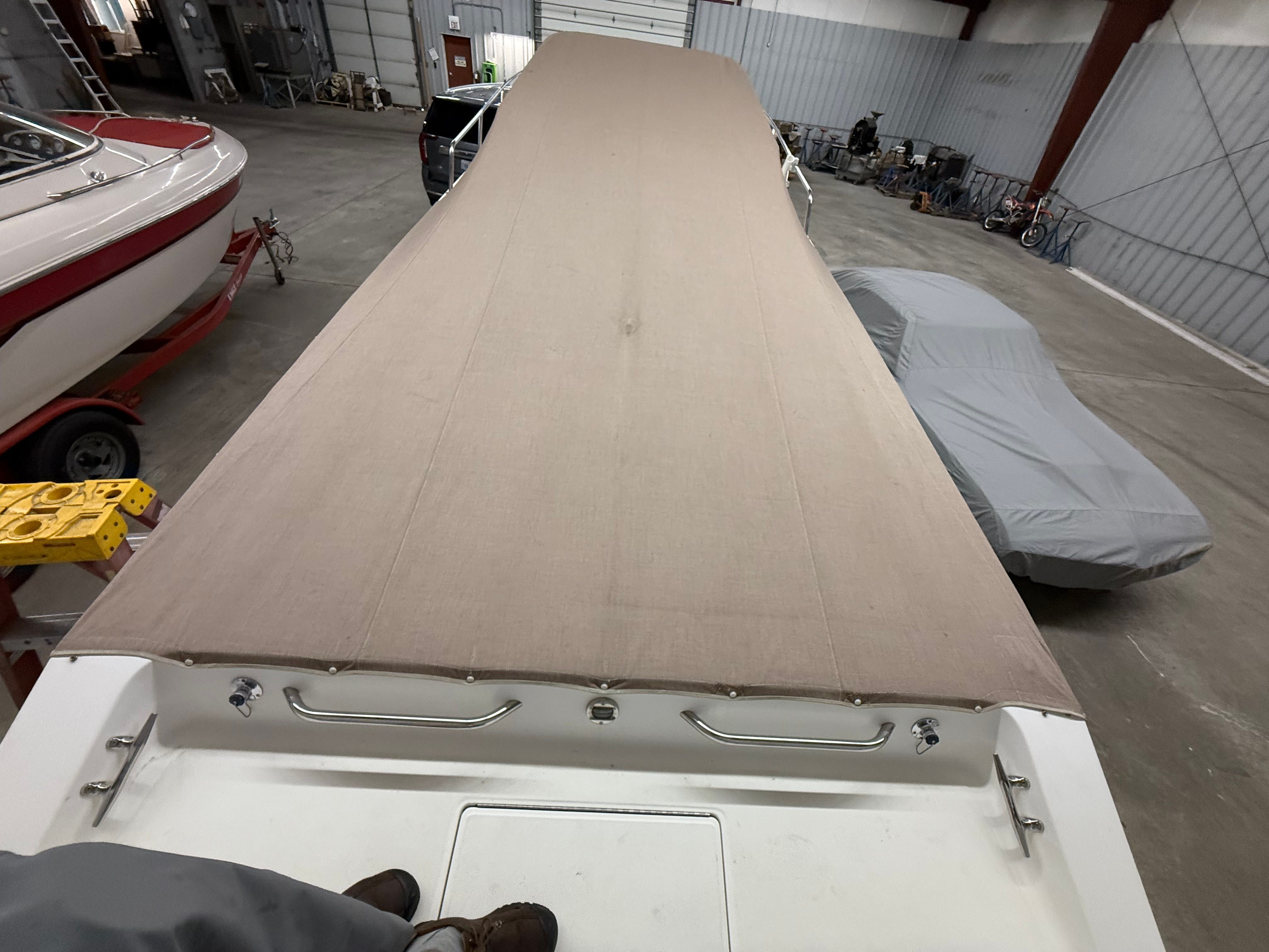 1999 Fountain 32 Sport Fish Cruiser with cover in storage facility.
