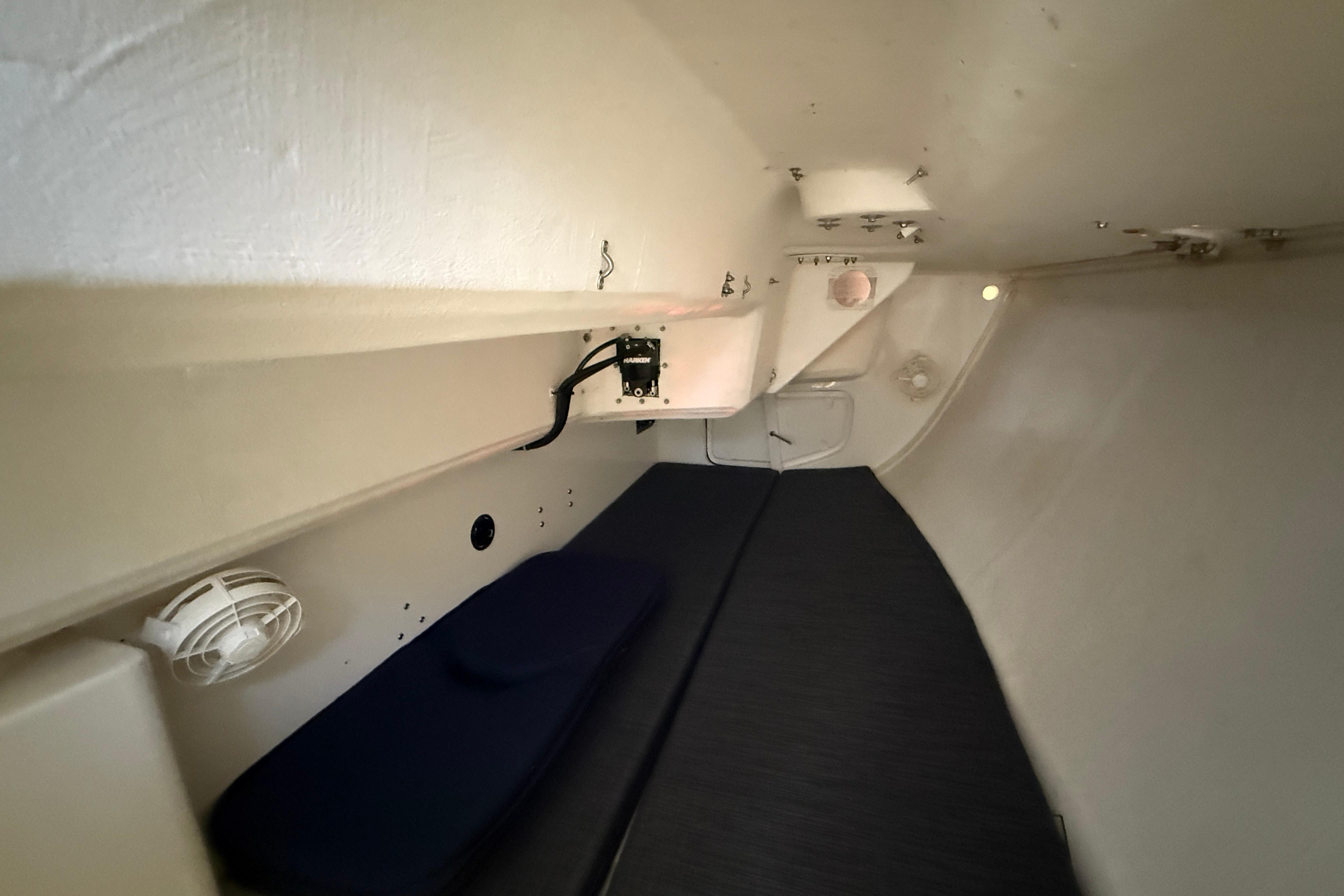 2018 J Boats J/121 interior cabin with minimalist design and compact sleeping area.