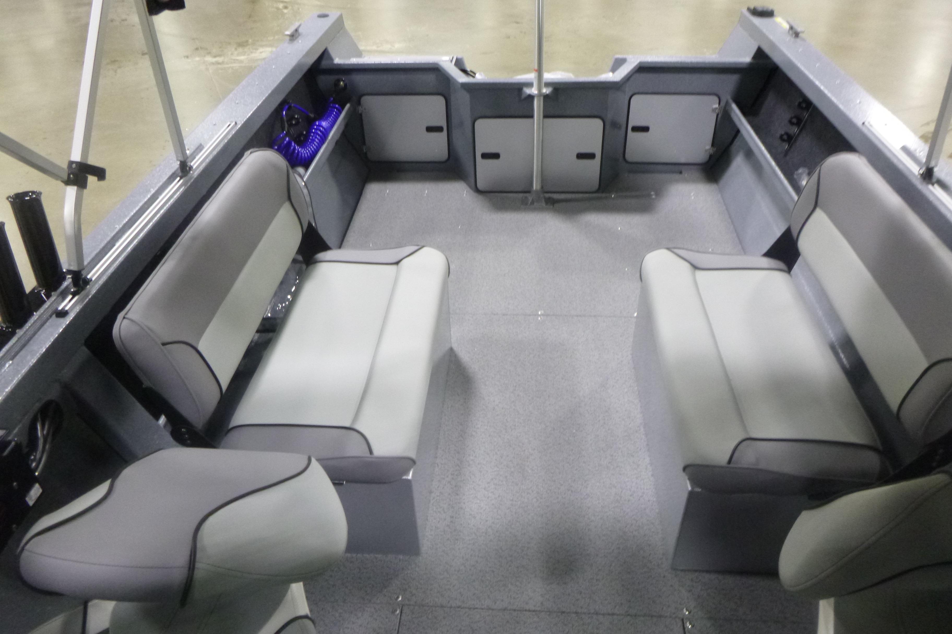 Interior of 2026 KingFisher 2025 Falcon boat with gray seating and spacious layout.