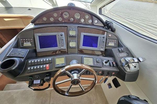 Cockpit of 2005 Sunseeker Manhattan 66 yacht with navigation controls and steering wheel.