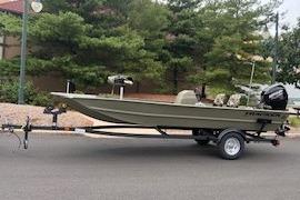 2026 Tracker Grizzly 1754 SC boat on trailer, parked on a street.