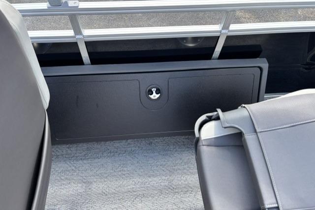 2026 Sun Tracker Fishin' Barge 22 DLX interior storage compartment with seating.