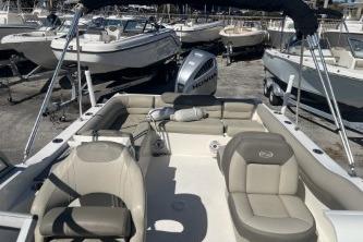 2022 Key West 239 DFS boat with seating, docked among other boats.