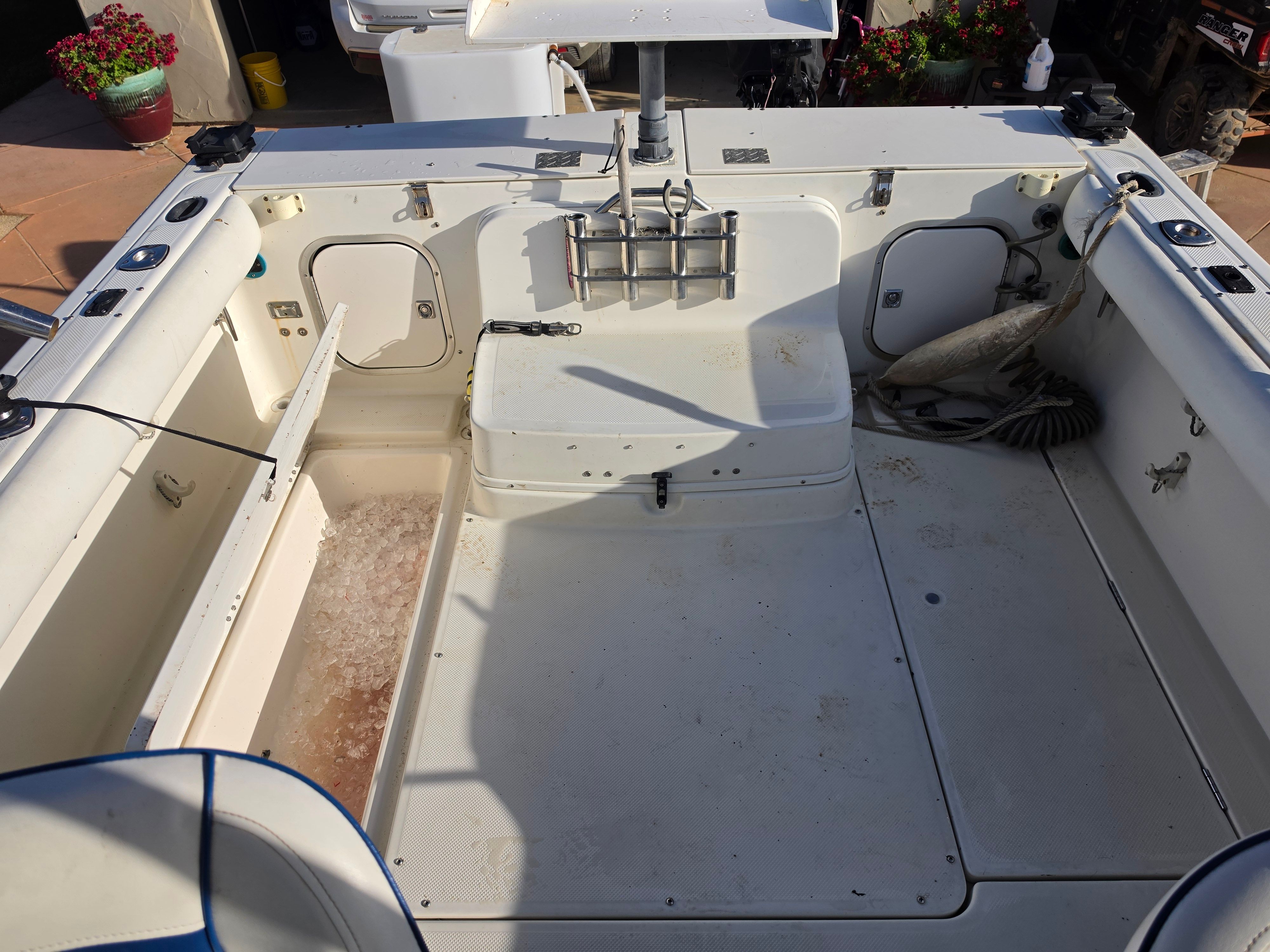 The image shows the cockpit of a 2001 Bayliner 2352 Trophy Walkaround with storage and rod holders.
