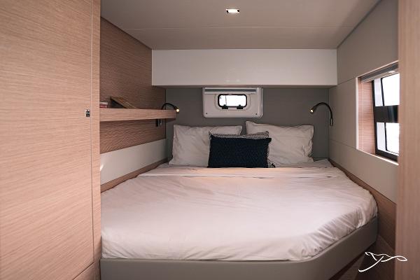 Luxurious cabin interior of 2025 Nautitech 40 Open catamaran with cozy bedding.
