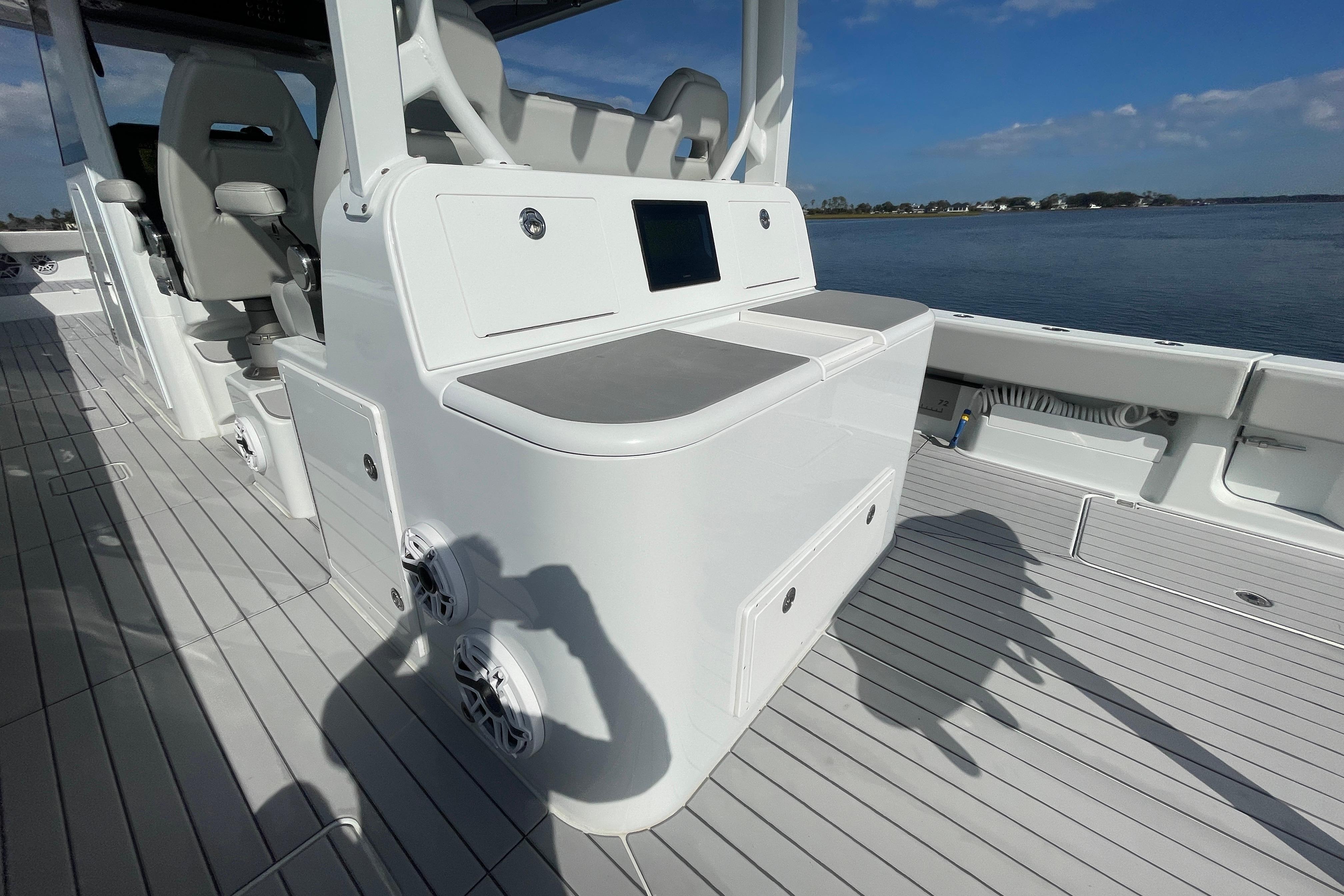 2022 Freeman 47 boat interior with seating and control panel, docked by calm waters.