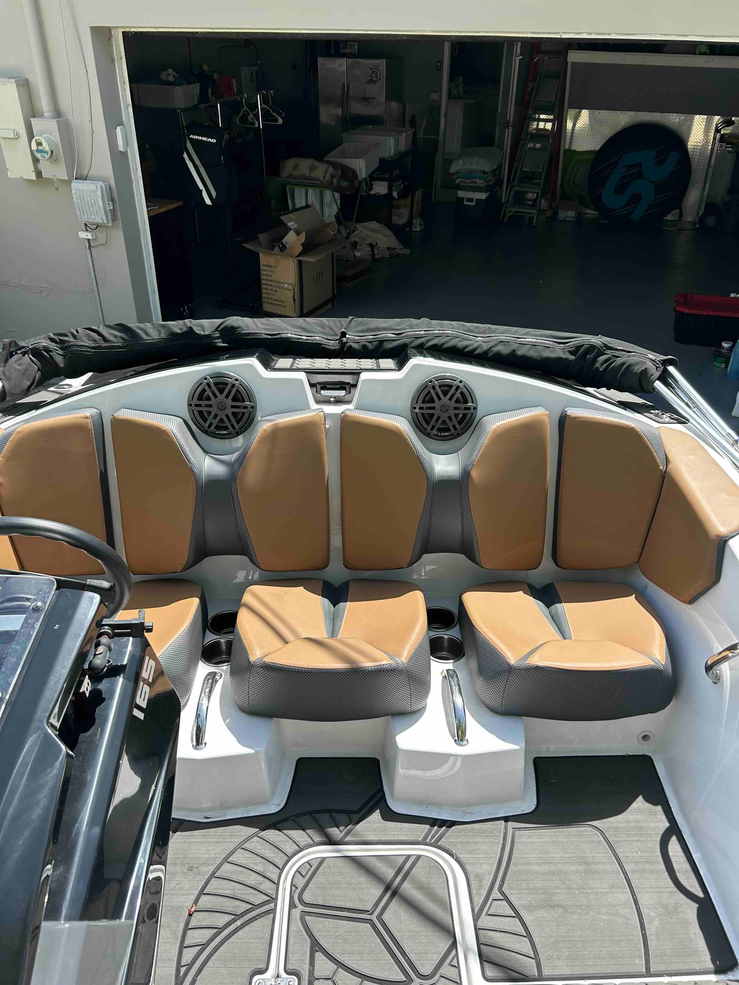 Interior view of a Scarab 165 ID boat with brown and gray seating.