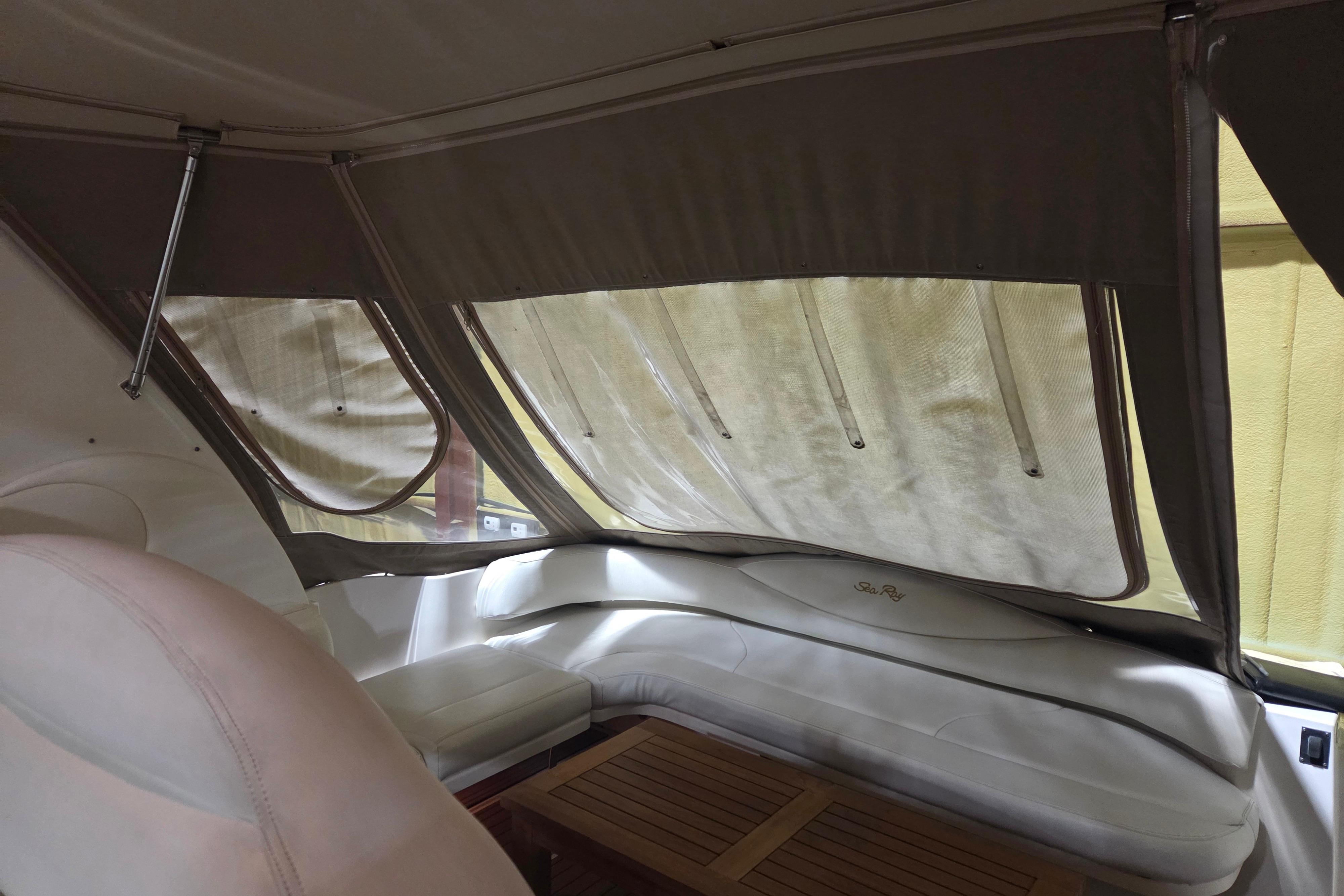 Interior of 2000 Sea Ray 410 Sundancer with cushioned seating and wooden table.