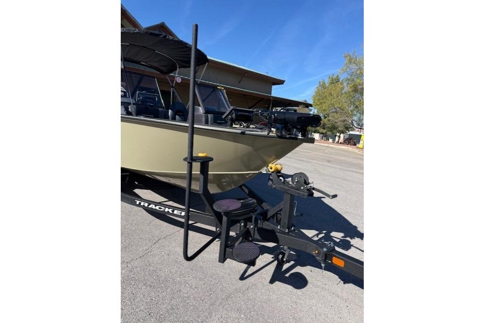 2026 Tracker Targa V-19 WT boat on trailer with step ladder, parked outdoors.