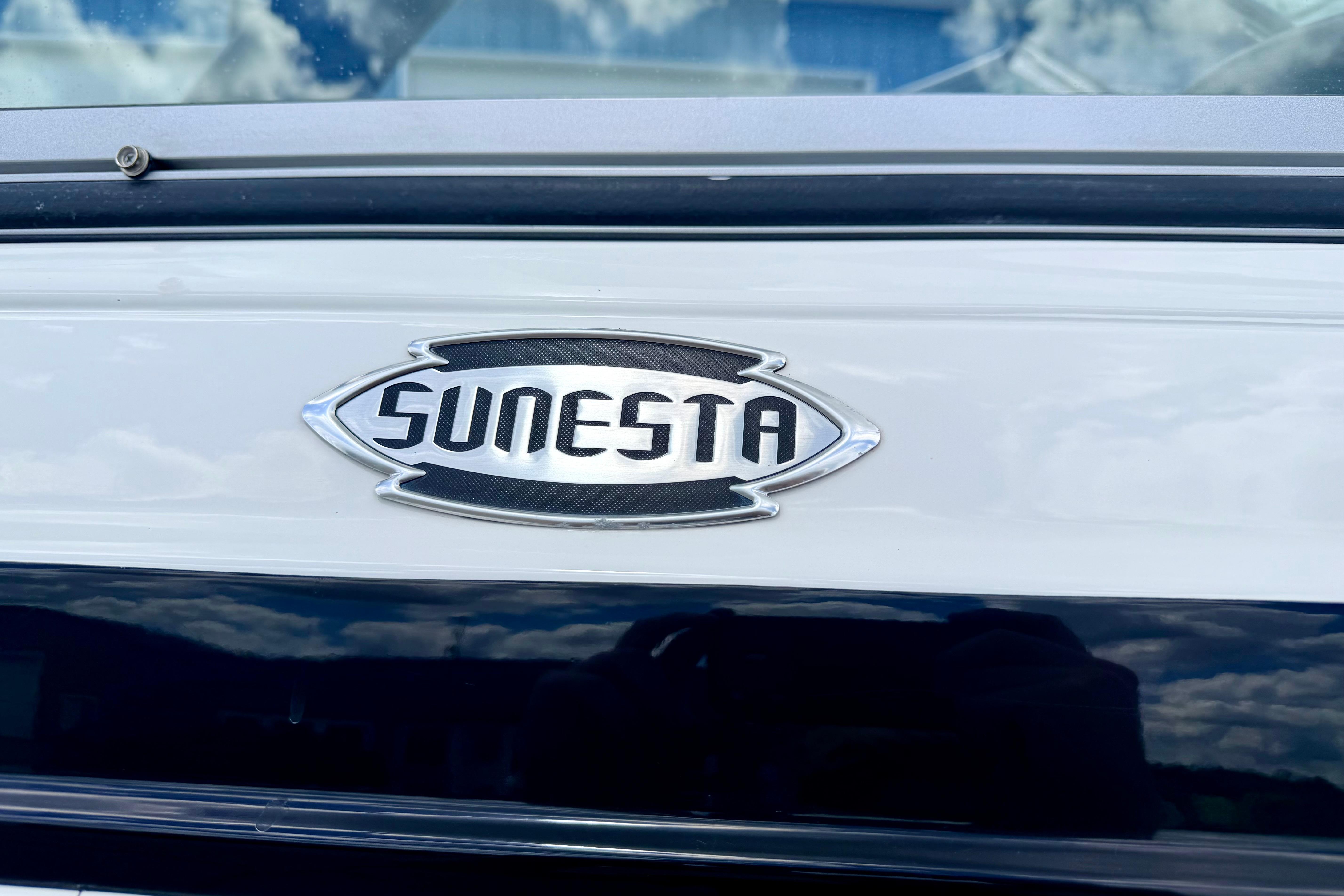 2015 Chaparral Sunesta 264 boat emblem against a reflective surface.