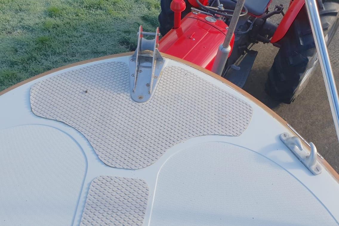 Bow of a 1989 Fairey Spearfish MKIII boat with red tractor in background.