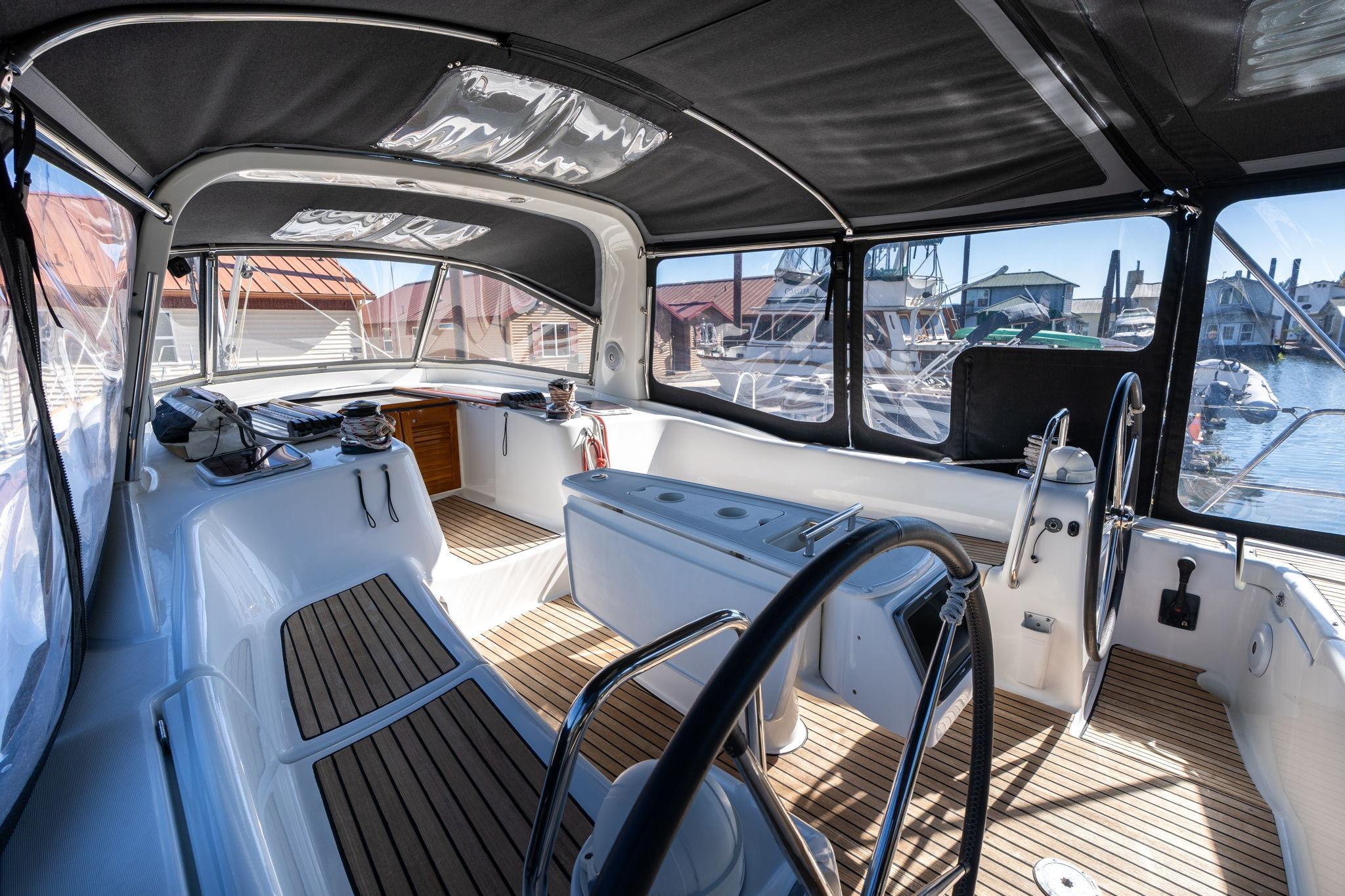 Interior view of 2013 Beneteau Oceanis 50 yacht cockpit with wooden flooring.