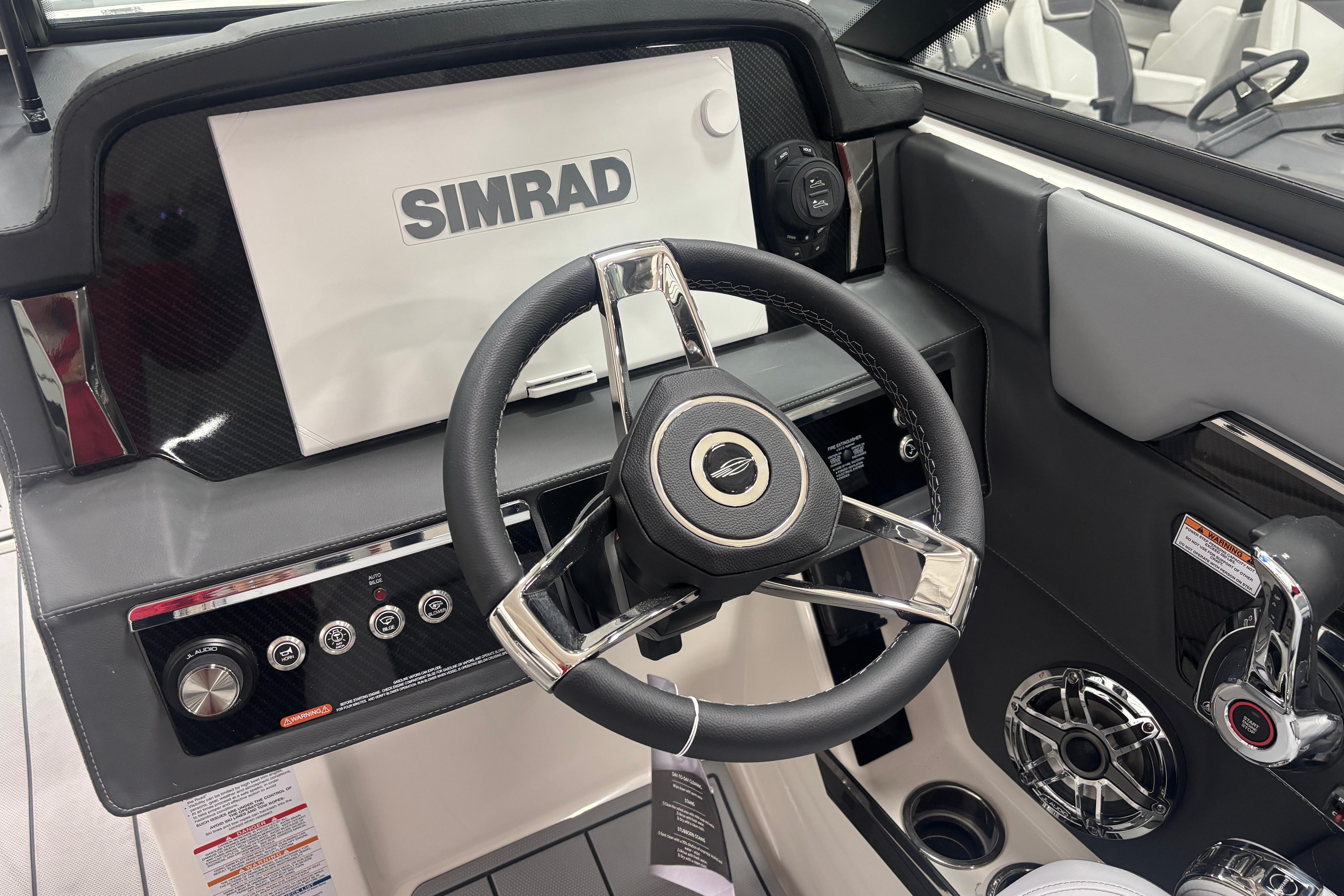 2026 Chaparral SSX 30 boat dashboard with Simrad display and steering wheel.