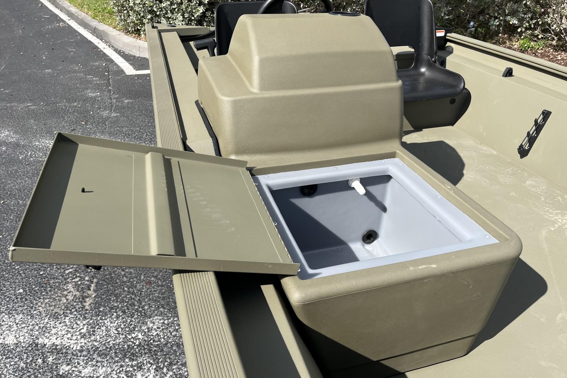 2026 Tracker Grizzly 1754 SC boat with open storage compartment, showcasing interior design.