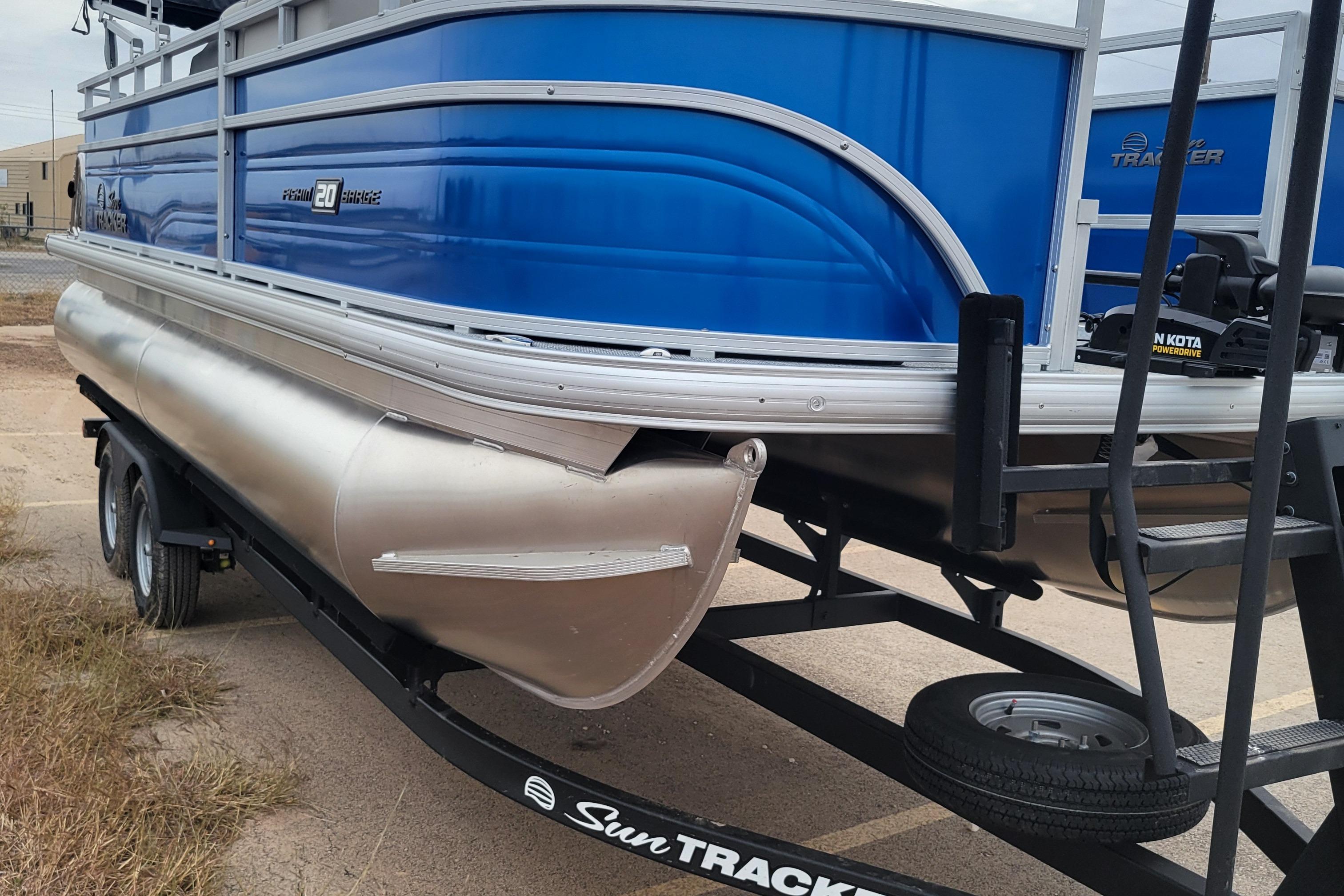 2026 Sun Tracker Fishin' Barge 20 DLX pontoon boat on trailer, side view.