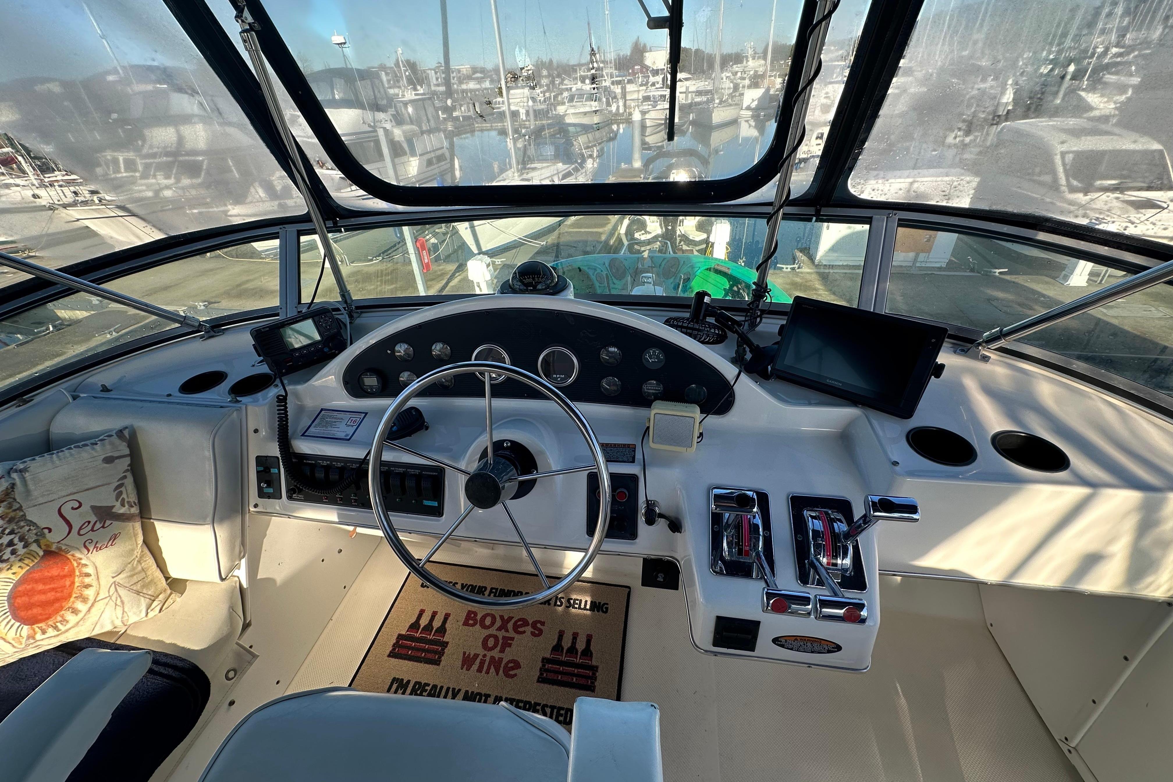 Cockpit of 2000 Bayliner 4087 Aft Cabin Motoryacht with steering wheel and navigation controls.
