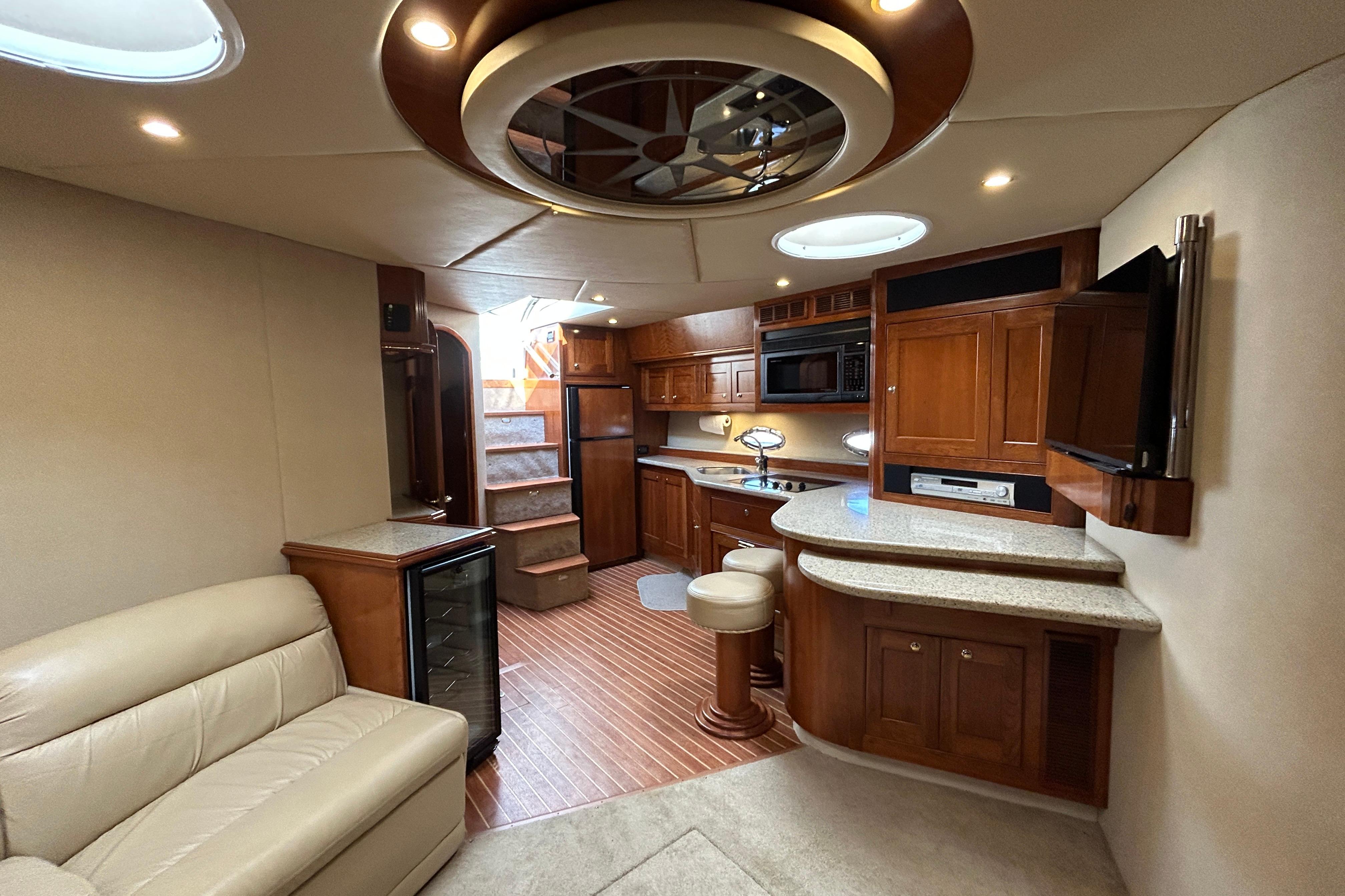 Luxurious interior of 2003 Cruisers Yachts 540 Express with modern kitchen and seating area.