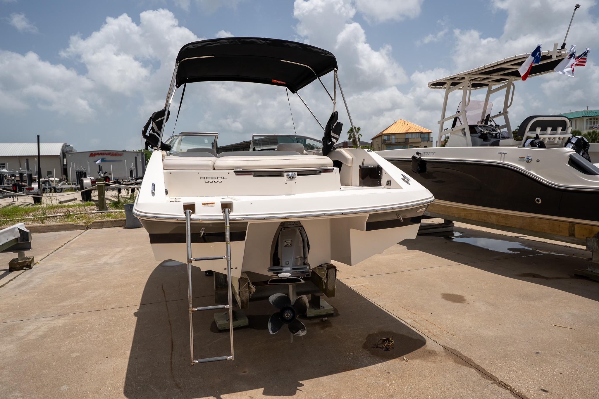 2008 Regal 2000 Bowrider boat with ladder, displayed outdoors on a sunny day.