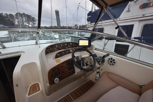 2000 Rinker 342 Fiesta Vee boat cockpit with steering wheel and navigation system.