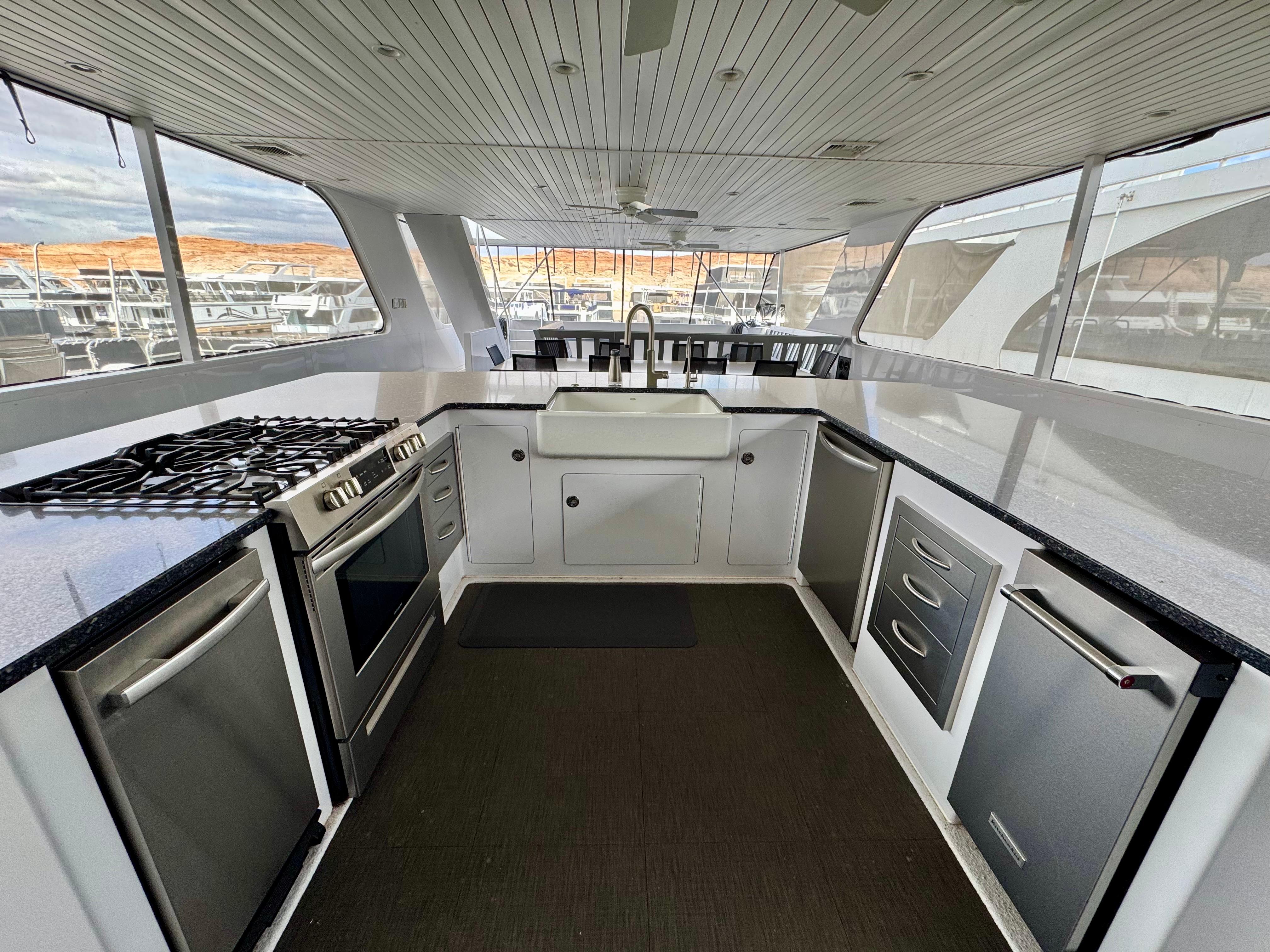 Modern kitchen interior on Adonia Pace Trip #7 houseboat, featuring stainless steel appliances, 2021 model.