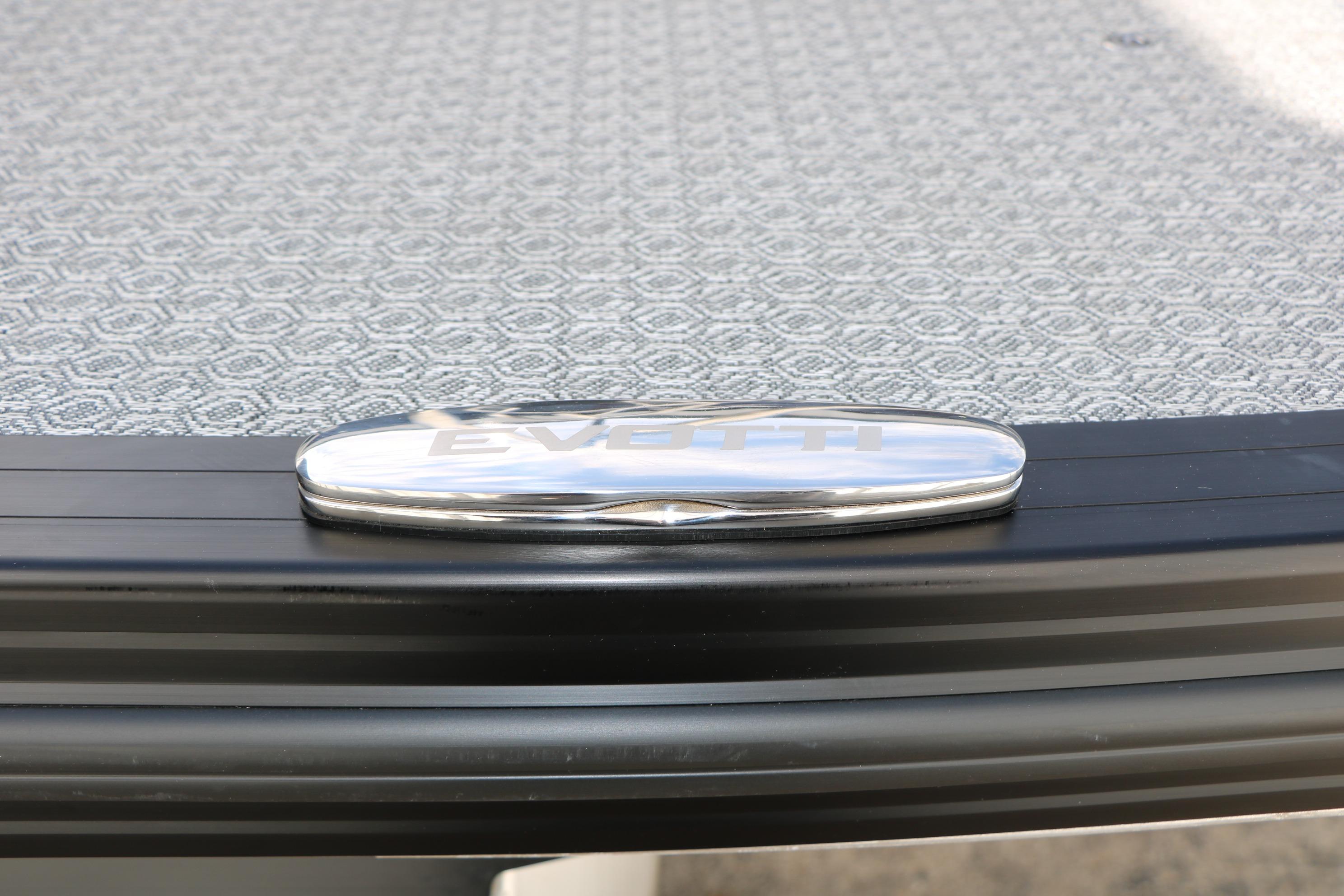 2026 Evotti 725 CS Tri-Toon logo on textured surface, showcasing sleek design.