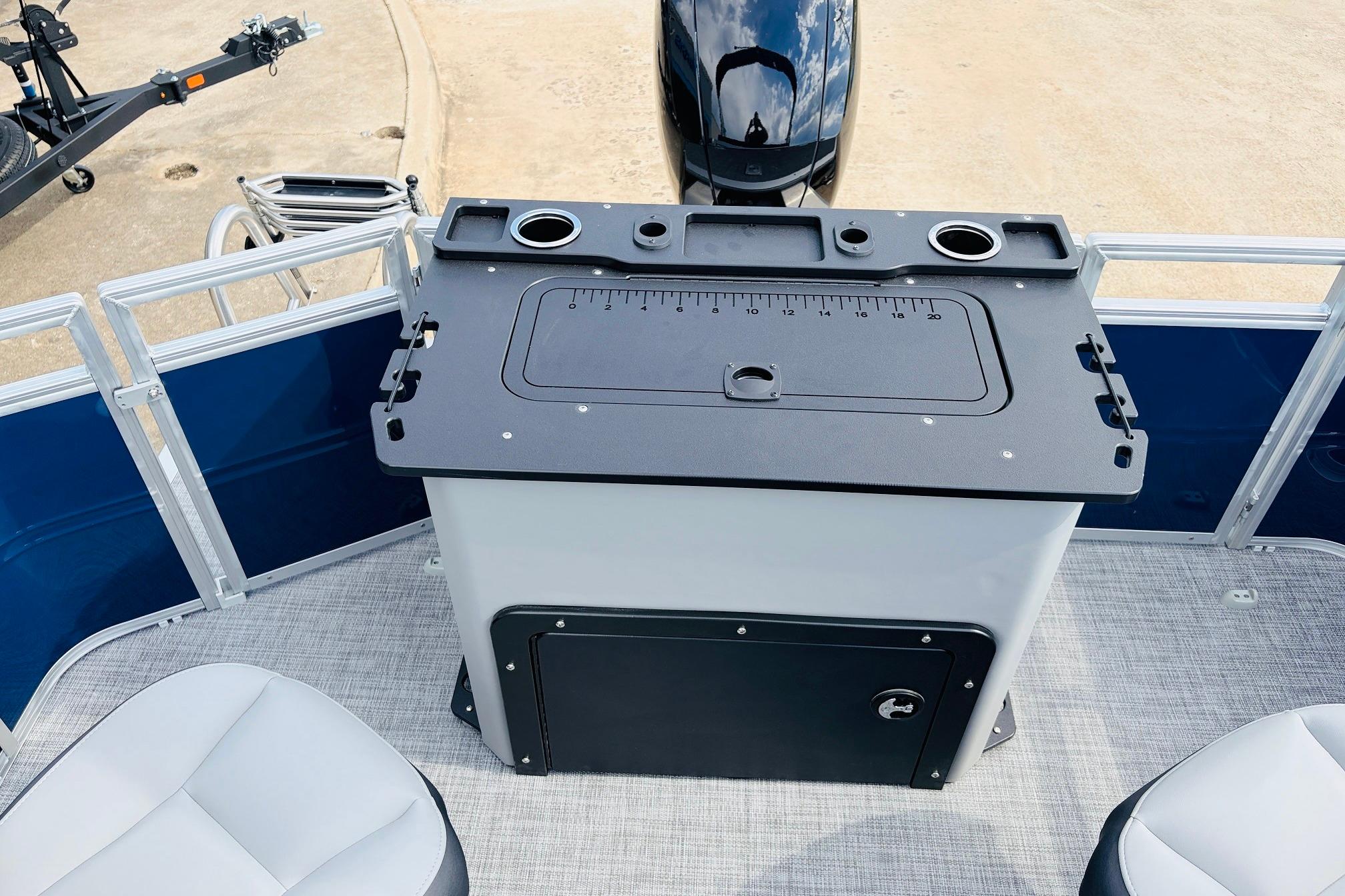 Fishing station on 2026 Sun Tracker SportFish 22 DLX pontoon boat with motor and seating.