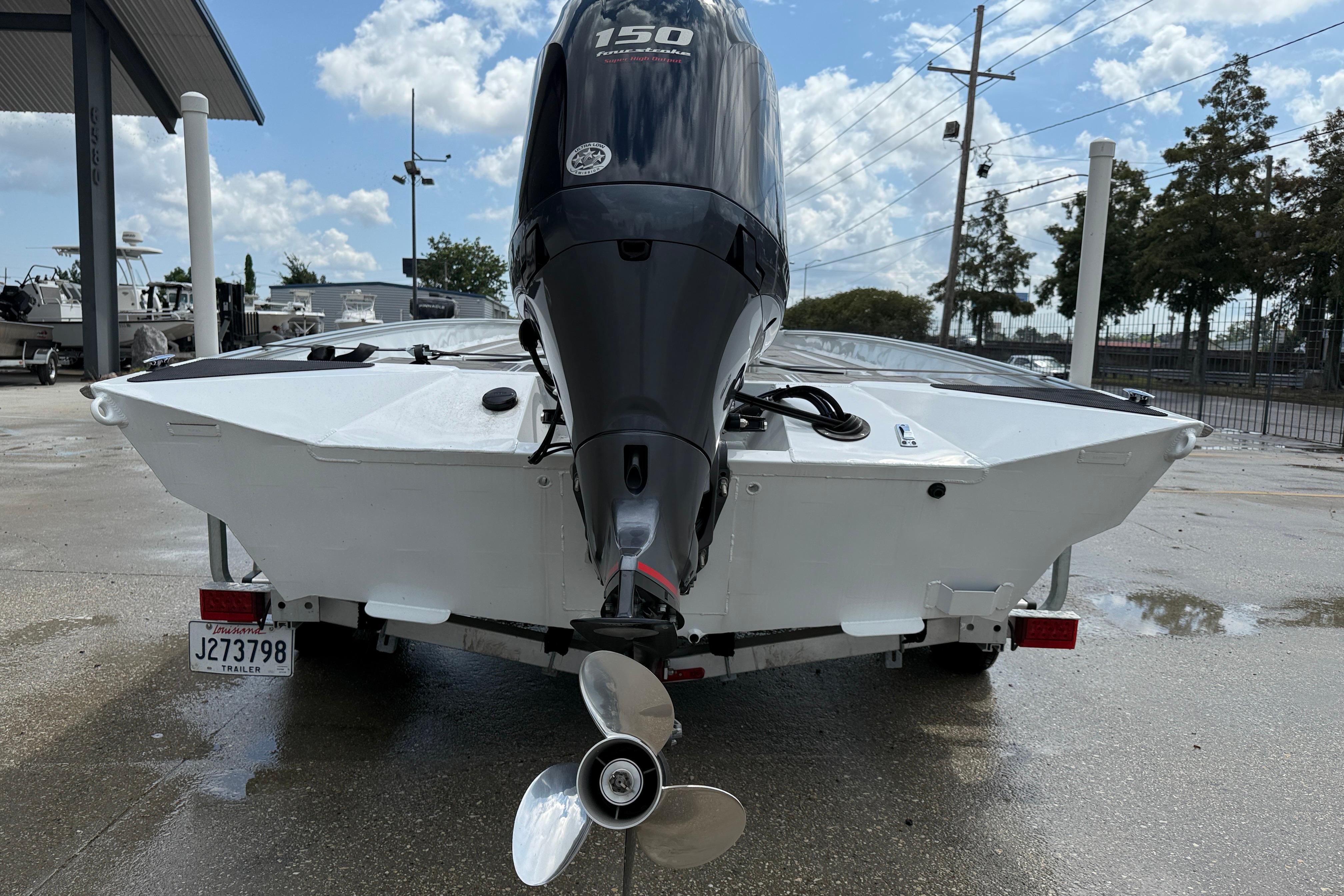 2024 Alweld 2070cc boat with powerful outboard motor, parked on a trailer.