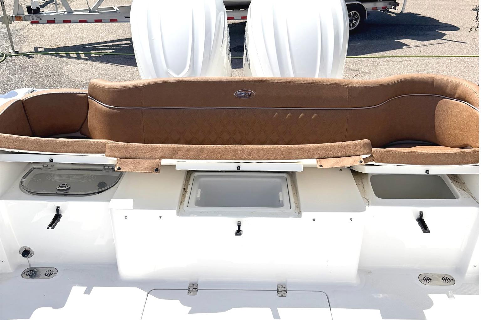 2026 Seahunt Ultra 305 CB boat interior with brown seating and storage compartments.