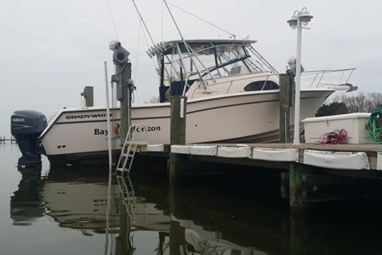 2002 Grady-White Marlin 300 boat docked at a marina.