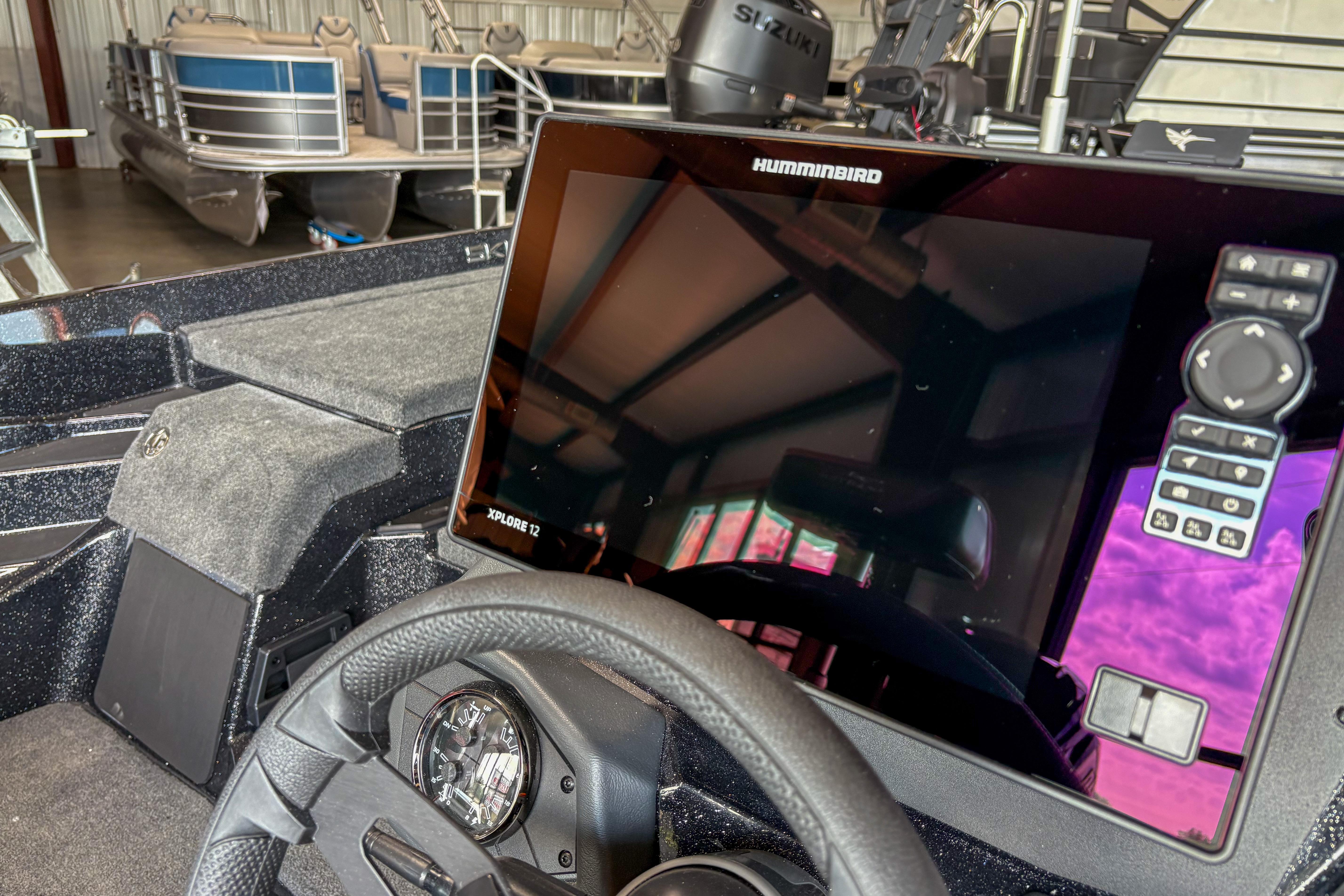 2026 Skeeter ZXE20 boat dashboard with Humminbird Xplore 12 display in a showroom.