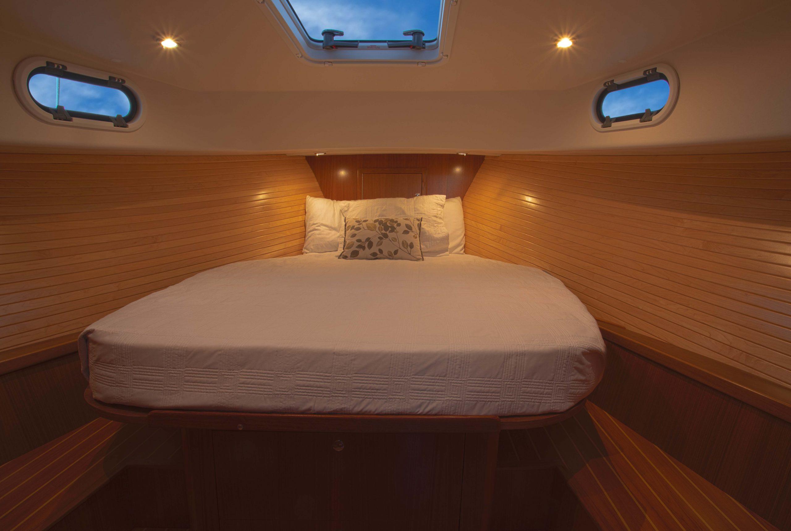 Luxurious cabin interior of 2024 True North 34 yacht with cozy bedding.